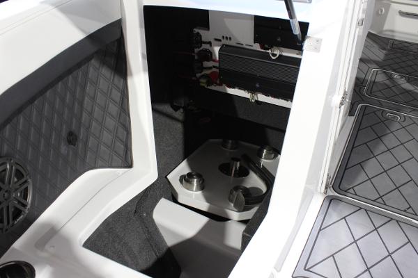 Interior view of 2025 Cobalt R6 boat, showcasing storage compartment and seating area.