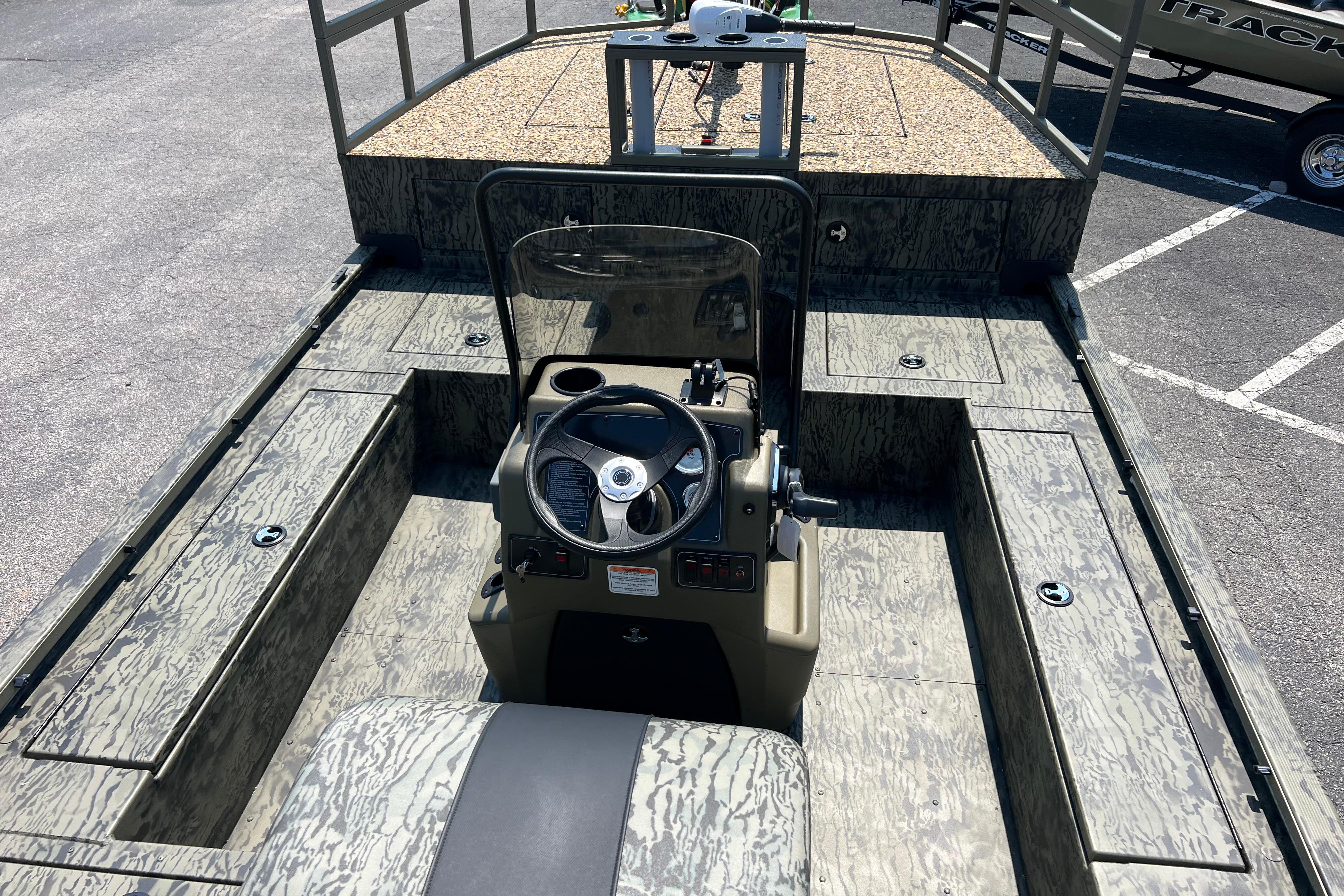 2026 Tracker Grizzly 2072 CC Sportsman Kicker boat interior with steering console.