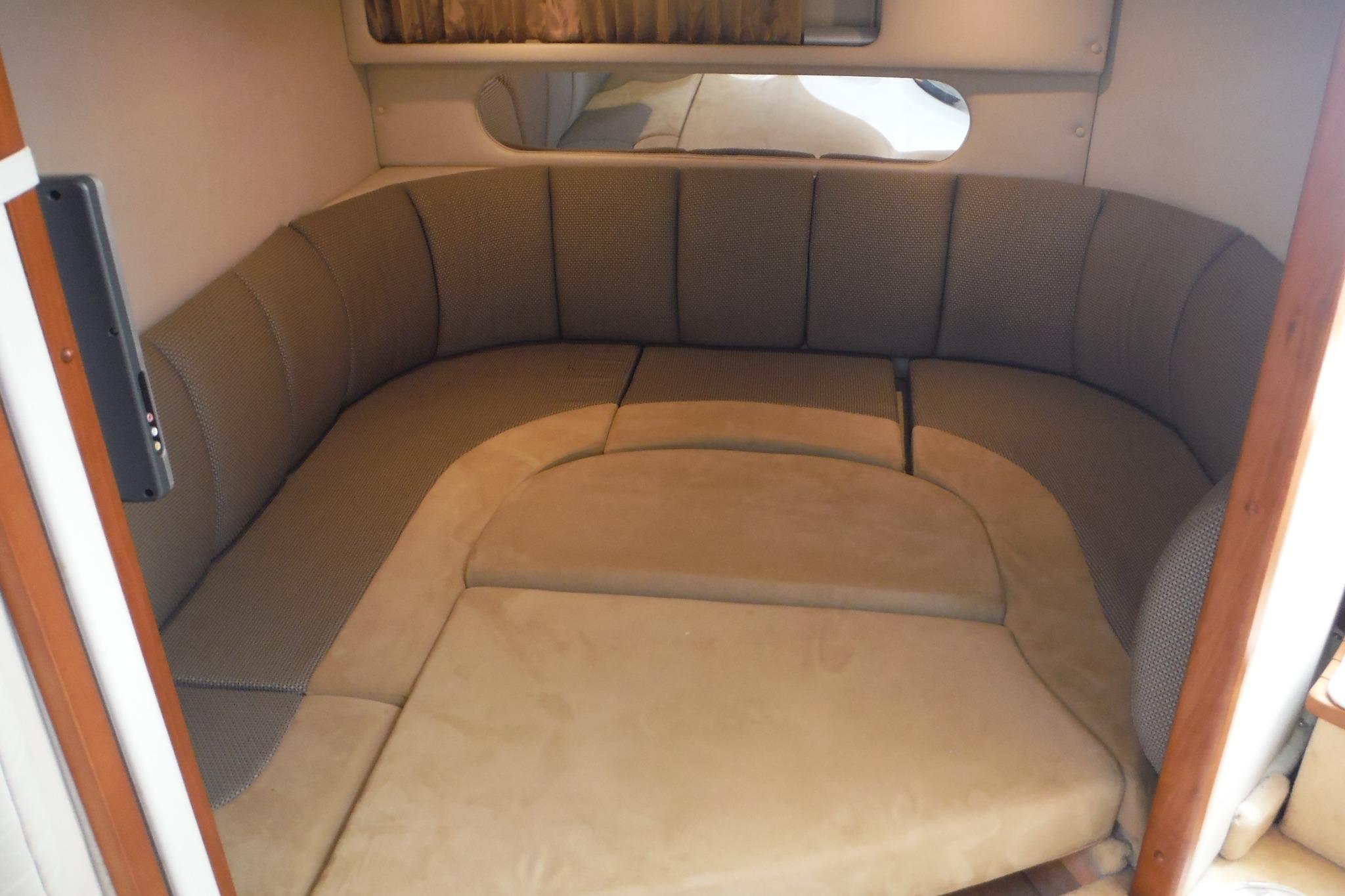 Interior cabin of 2005 Chaparral Signature 350 boat with cozy seating arrangement.