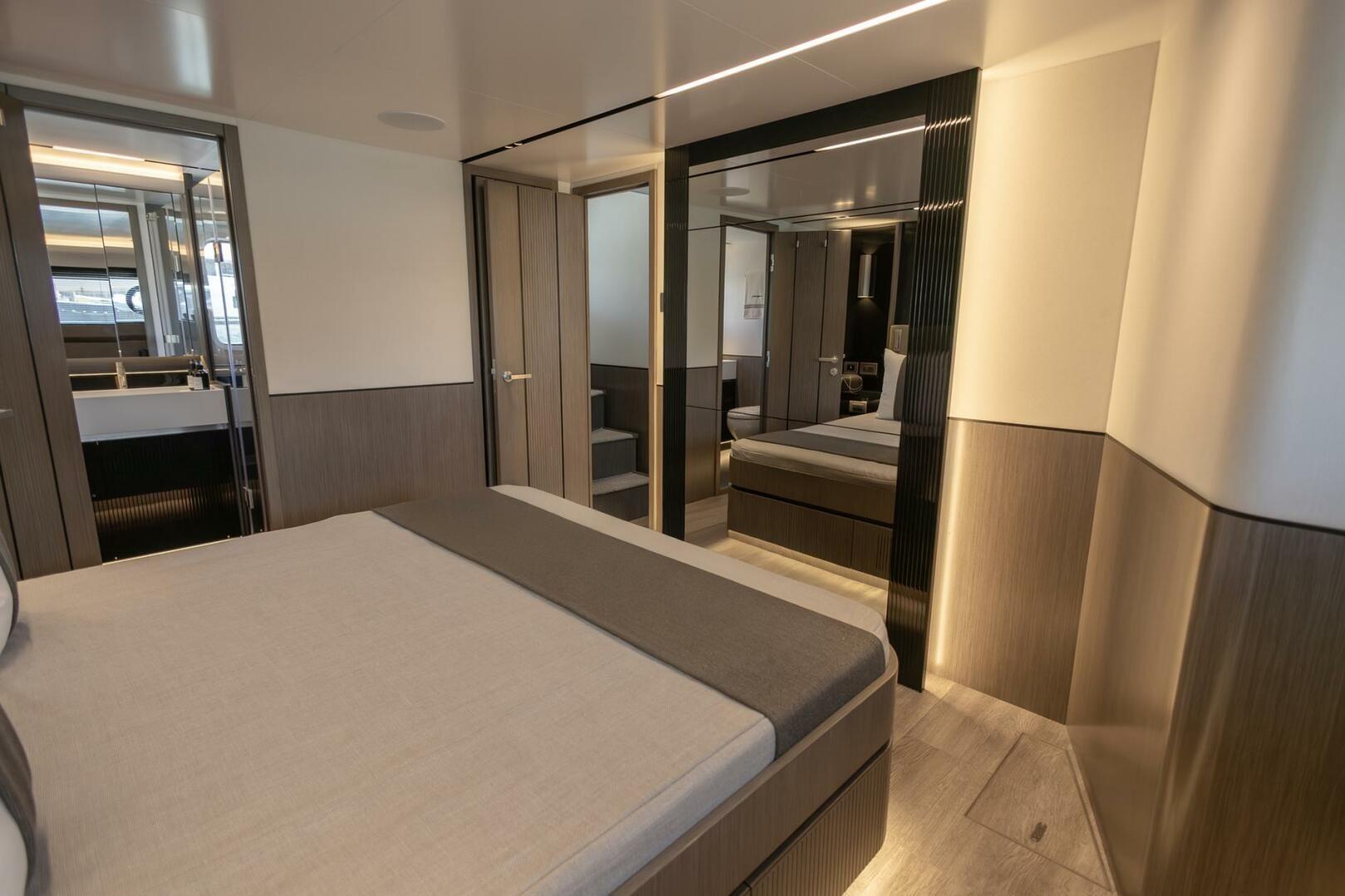 Luxurious interior of 2023 Pearl 72 yacht featuring modern bedroom design and elegant finishes.
