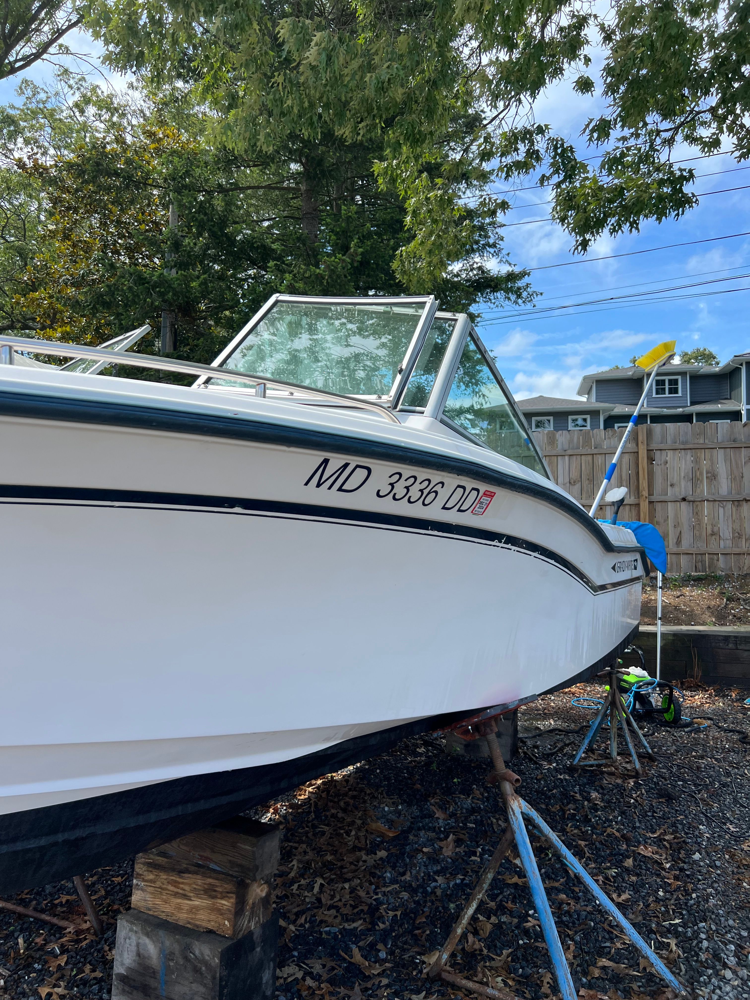 A 1993 Grady-White 192 Tourney boat is on a stand outdoors.