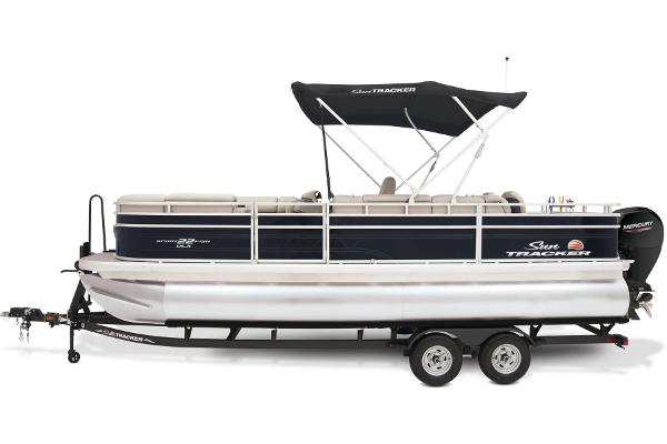 2024 Sun Tracker SportFish 22 DLX pontoon boat with canopy on trailer.