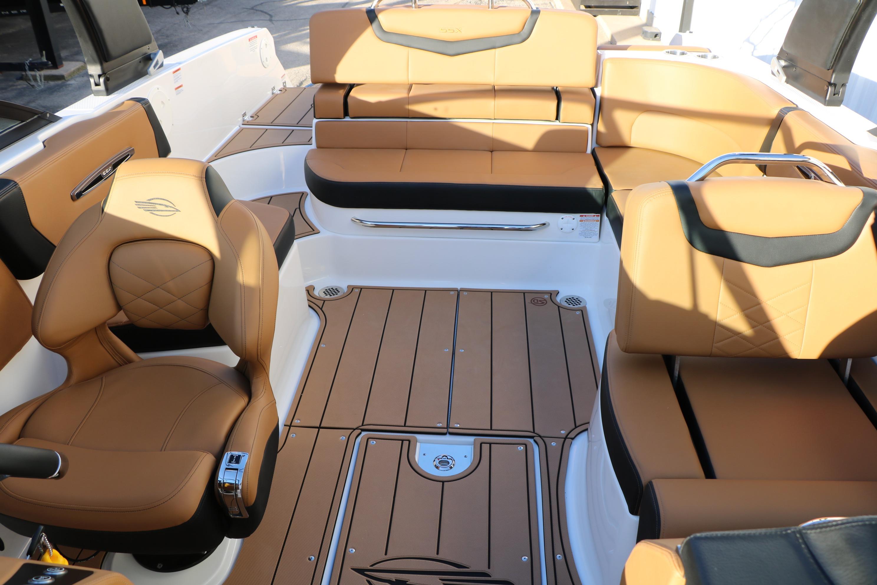 Luxurious interior of 2026 Chaparral 247 SSX boat with tan leather seating.