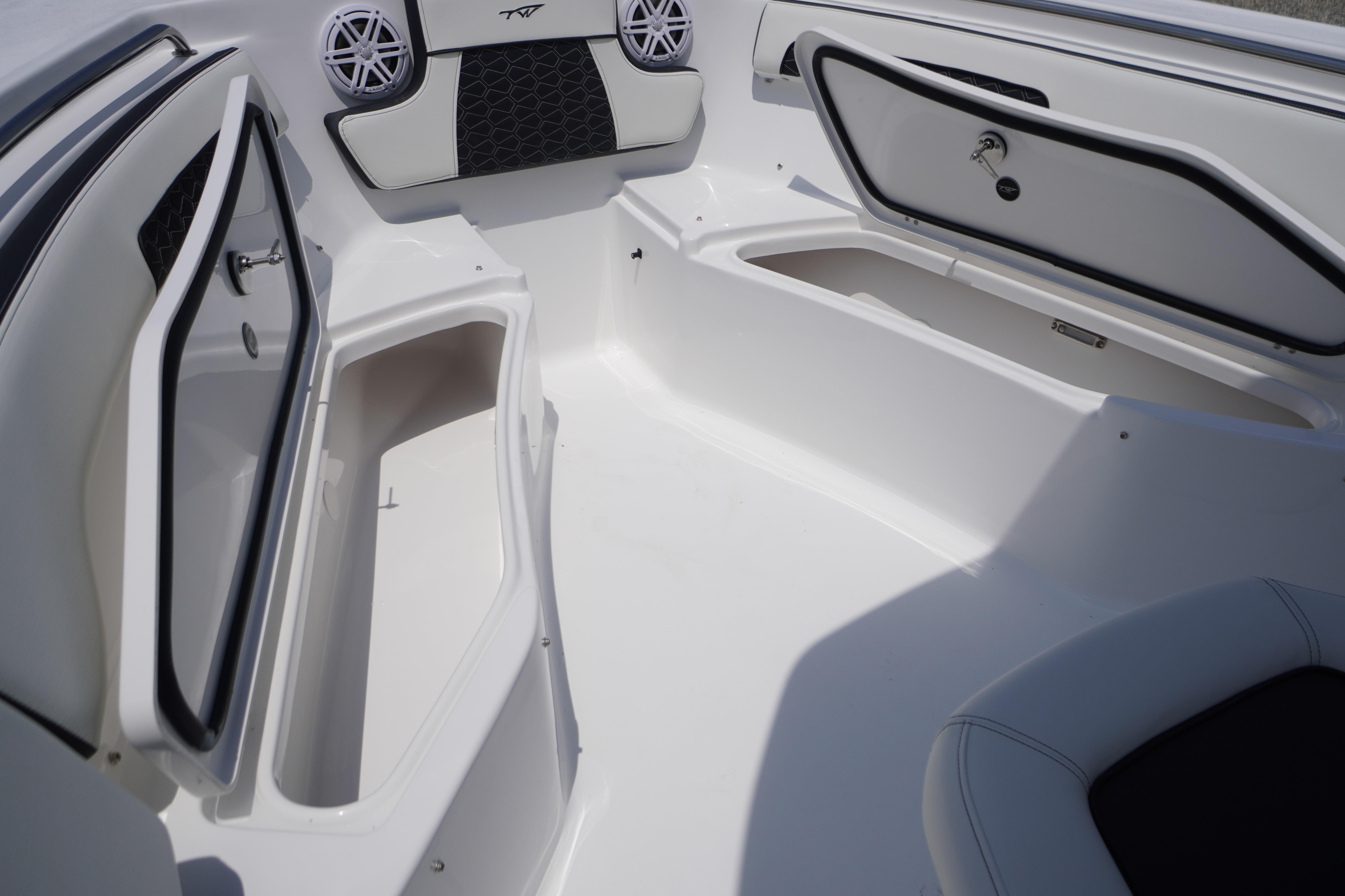 2027 Tidewater 220 CC Adventure boat interior with open storage compartments and speakers.