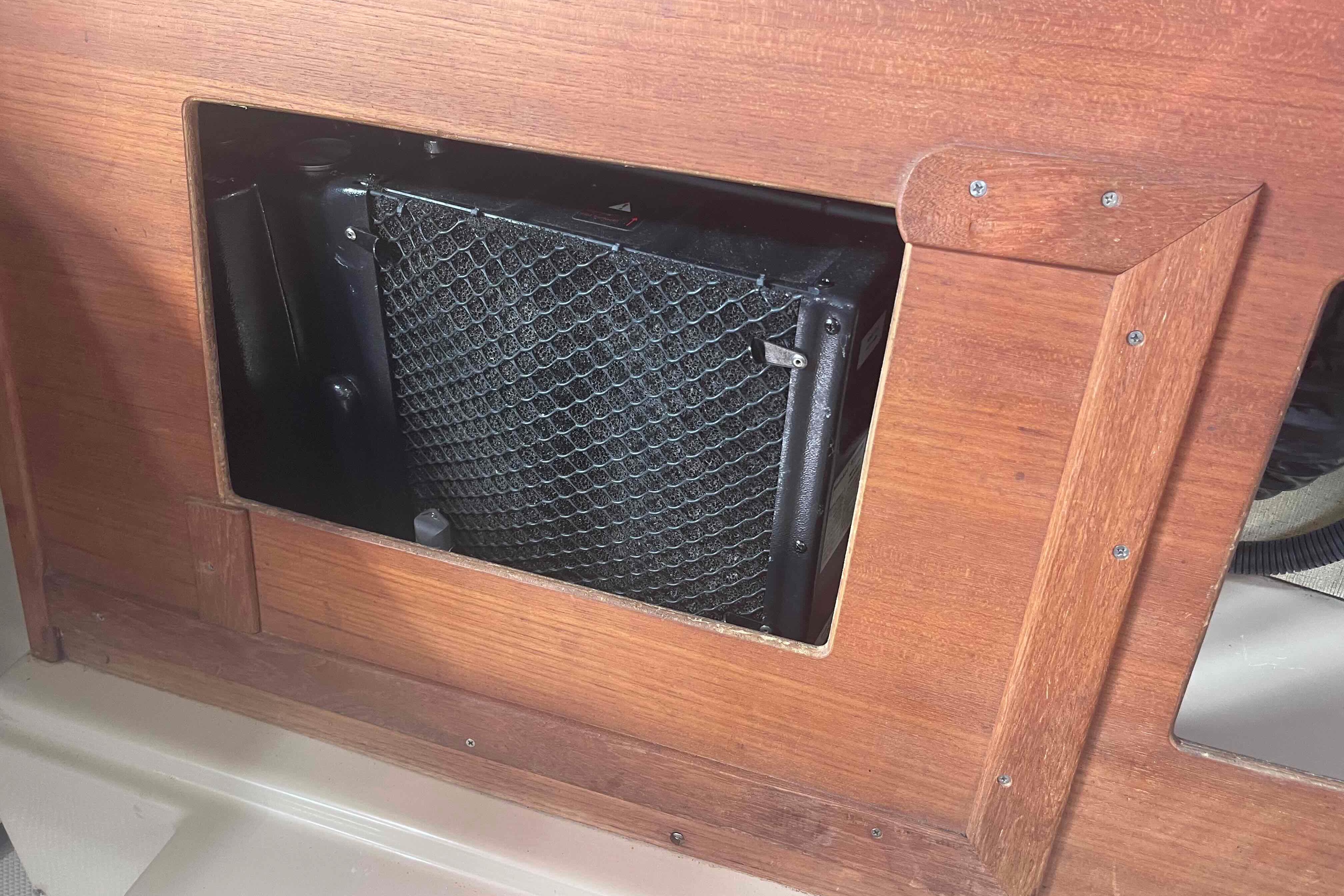 1989 Island Packet 35 interior with wooden panel and ventilation system.