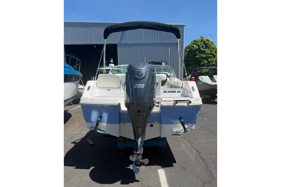 2024 Robalo R207 Dual Console boat with Yamaha 200 engine, parked outdoors.