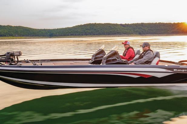 2026 Ranger Z521R Garmin Cup-Equipped boat cruising on a serene lake at sunset.