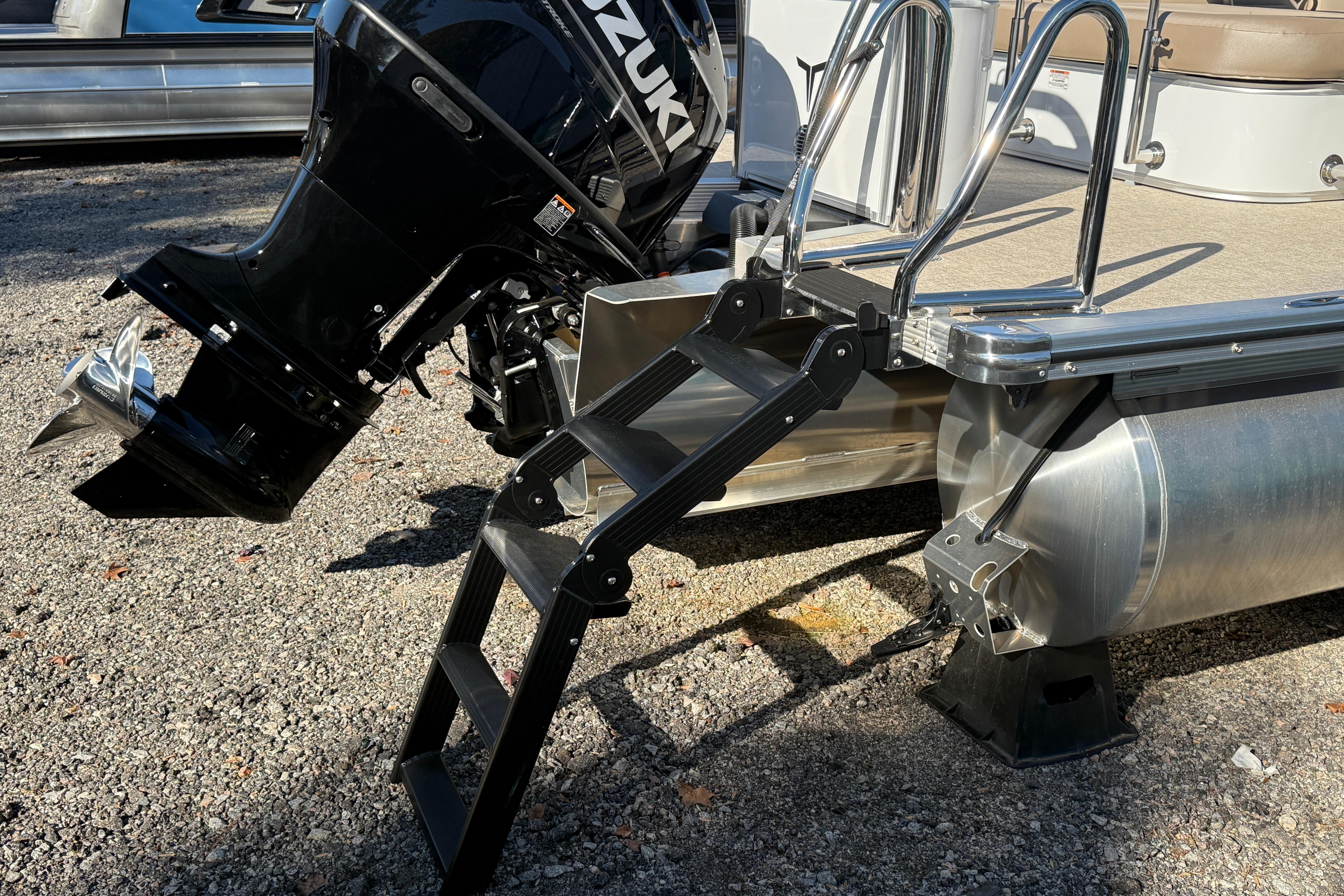 2026 Tahoe Pontoon LTZ Versatile Rear Lounger with Suzuki outboard motor and boarding ladder.