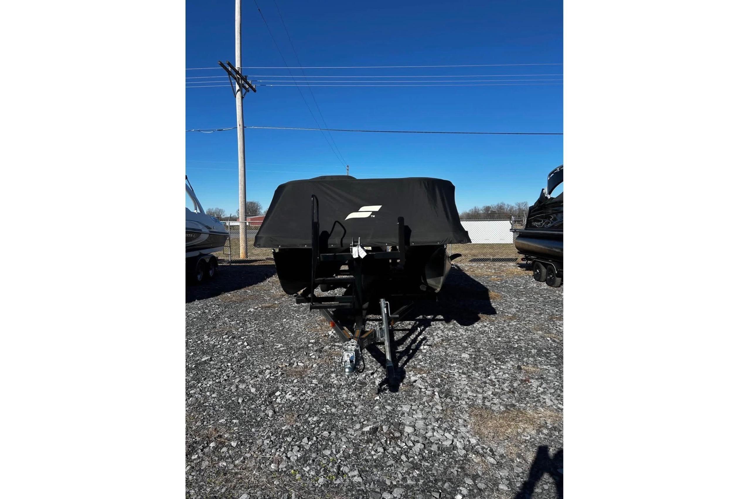 2023 Starcraft MX 25 DL DH boat with cover on gravel lot.