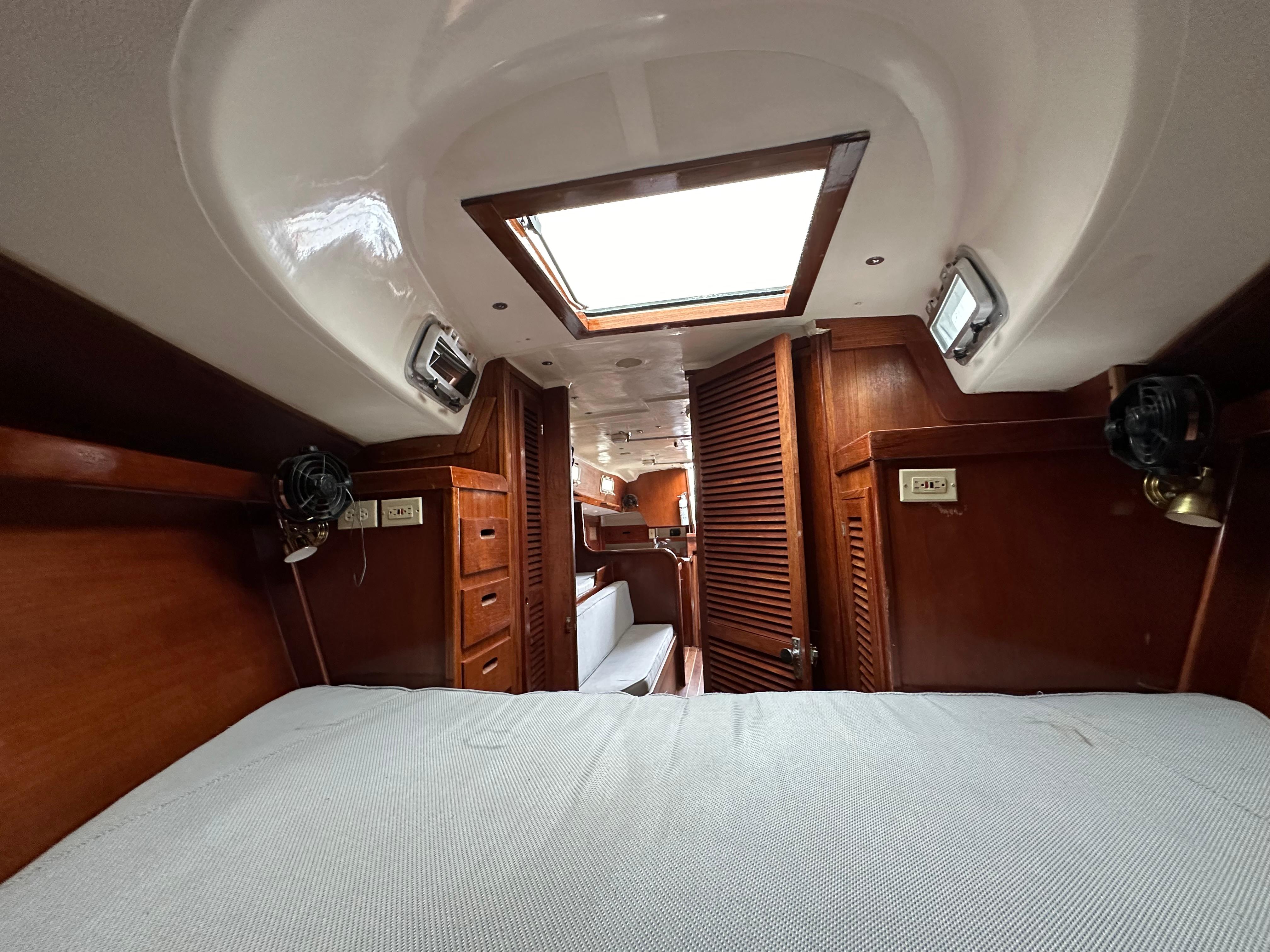 Interior of 1981 Tartan 37 sloop with wooden cabinetry and skylight.