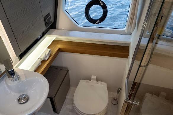 Luxurious 2022 Tiara Sport 43 LE yacht bathroom with modern fixtures and ocean view.