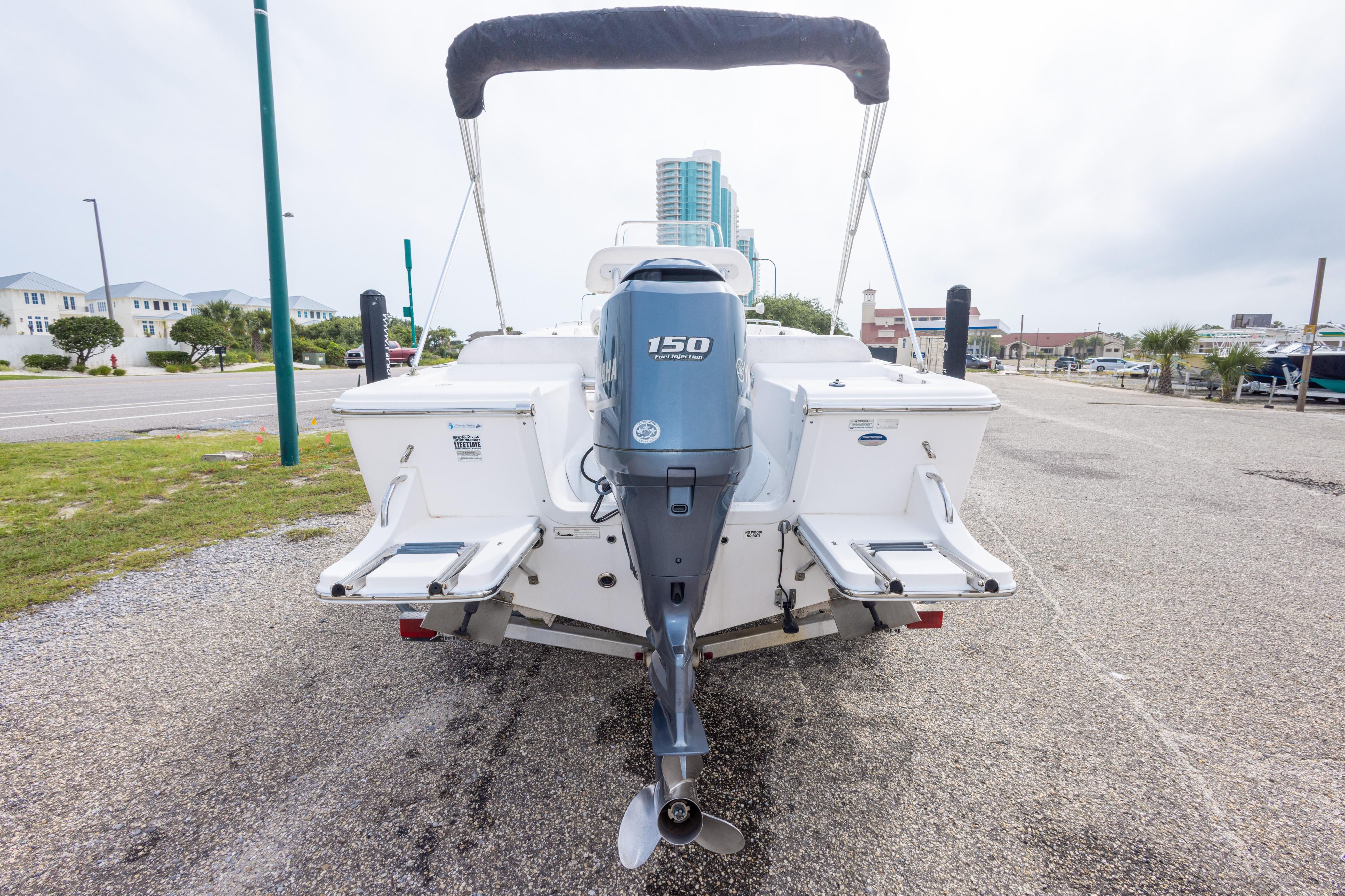 2014 Sea Fox 209 Commander boat with 150 horsepower engine, parked on a coastal road.