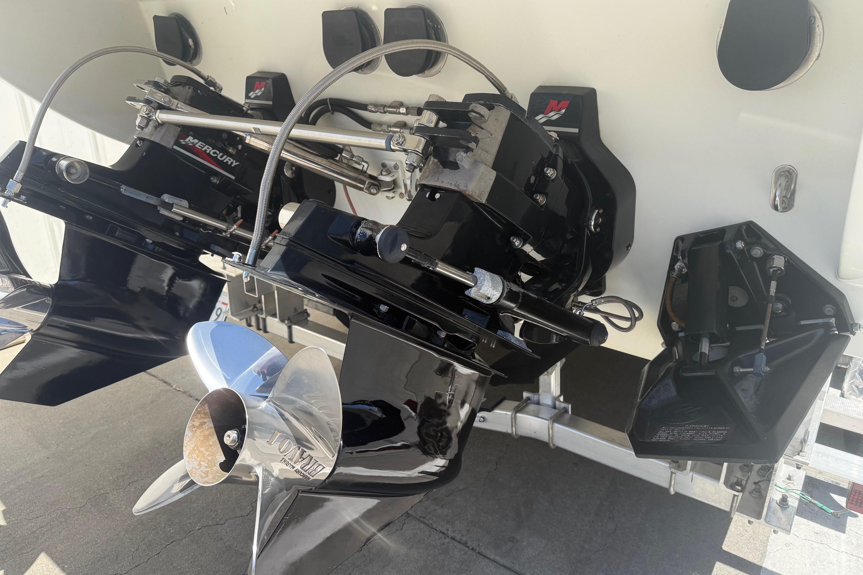 2001 Formula 353 FASTech boat with dual Mercury outboard engines and polished propellers.
