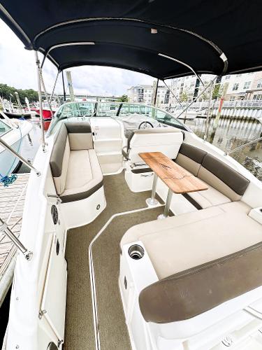 2015 Sea Ray 260 Sundancer boat interior with seating and table, docked at marina.