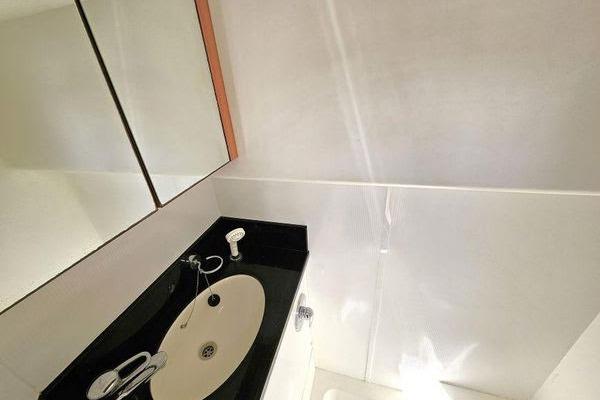Bathroom interior of 2005 Sunseeker Manhattan 66 yacht with sleek sink and mirror.