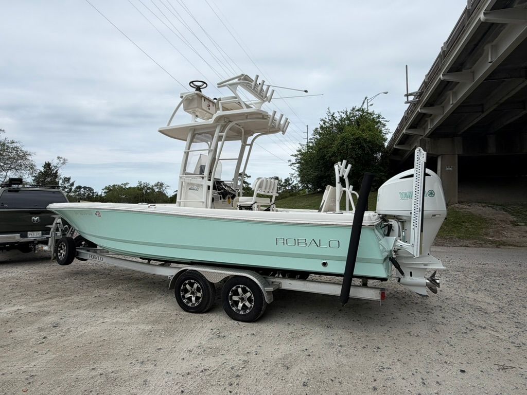 2018 Robalo 246 Cayman SD boat on trailer under bridge.