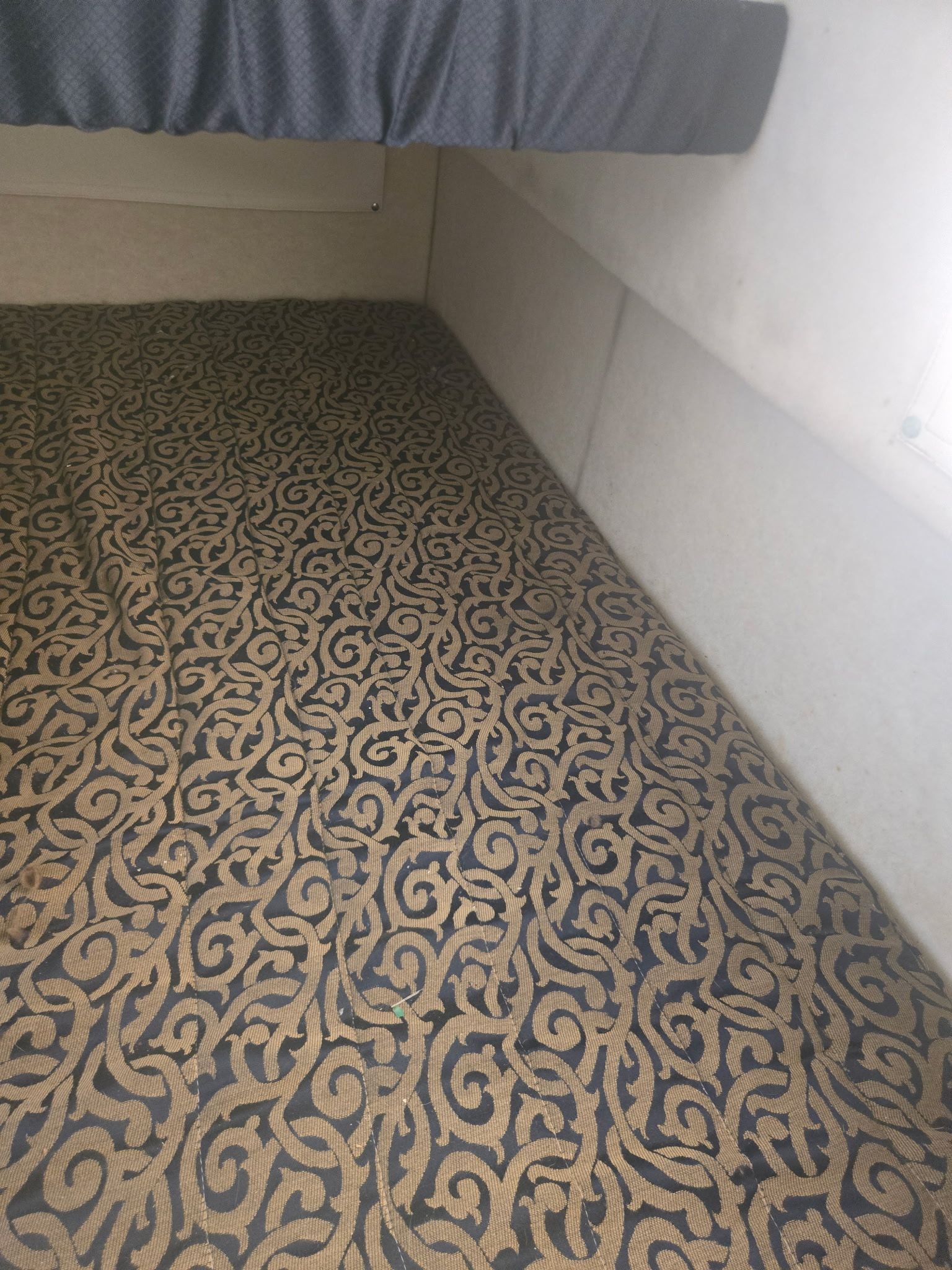 Interior of a 2003 Bayliner 28 with patterned carpet.