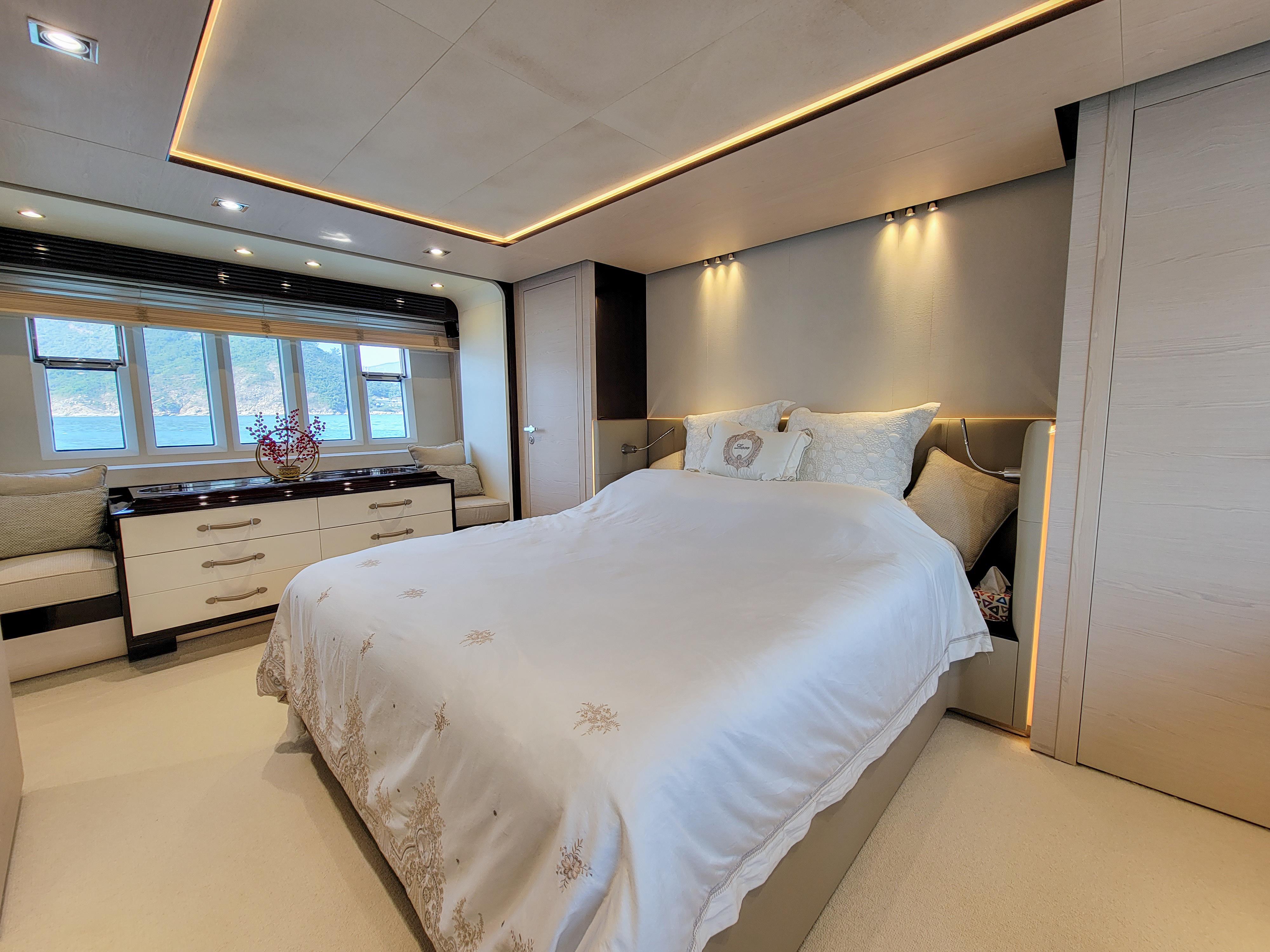 Luxurious bedroom interior on a 2015 Azimut 80 yacht, featuring elegant lighting and modern decor.