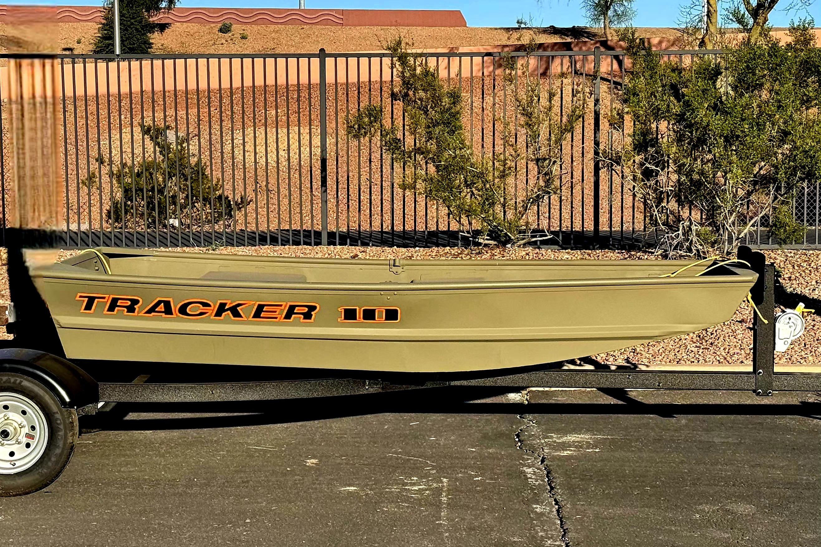 2026 Tracker Grizzly 10 Jon boat on trailer, parked outdoors.