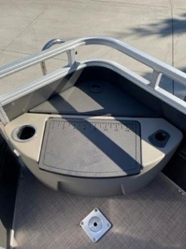 2024 Sun Tracker Fishin' Barge 20 DLX bow area with storage and cup holders.