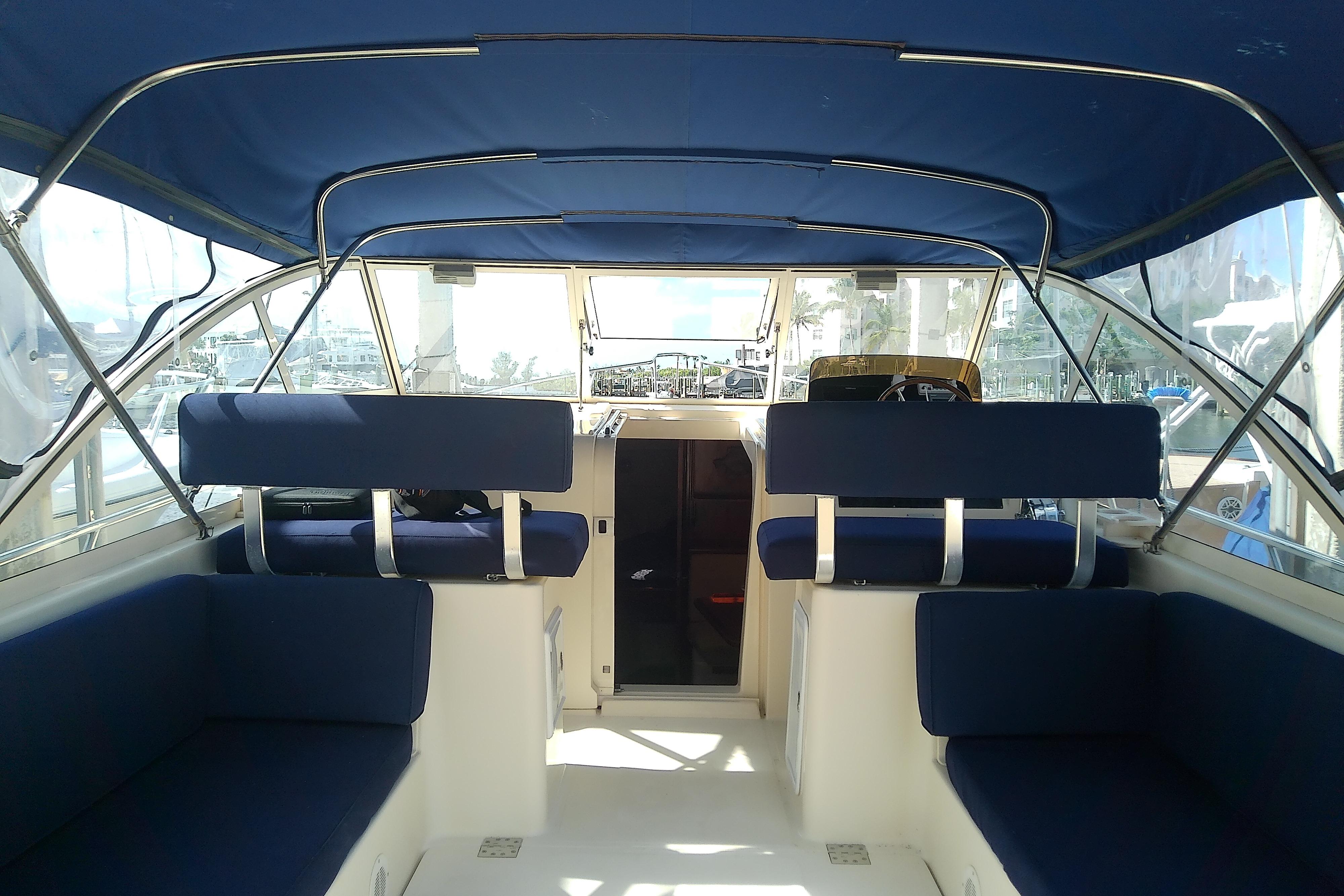 Interior view of 2004 Mainship 34 Pilot II boat with blue seating and canopy.