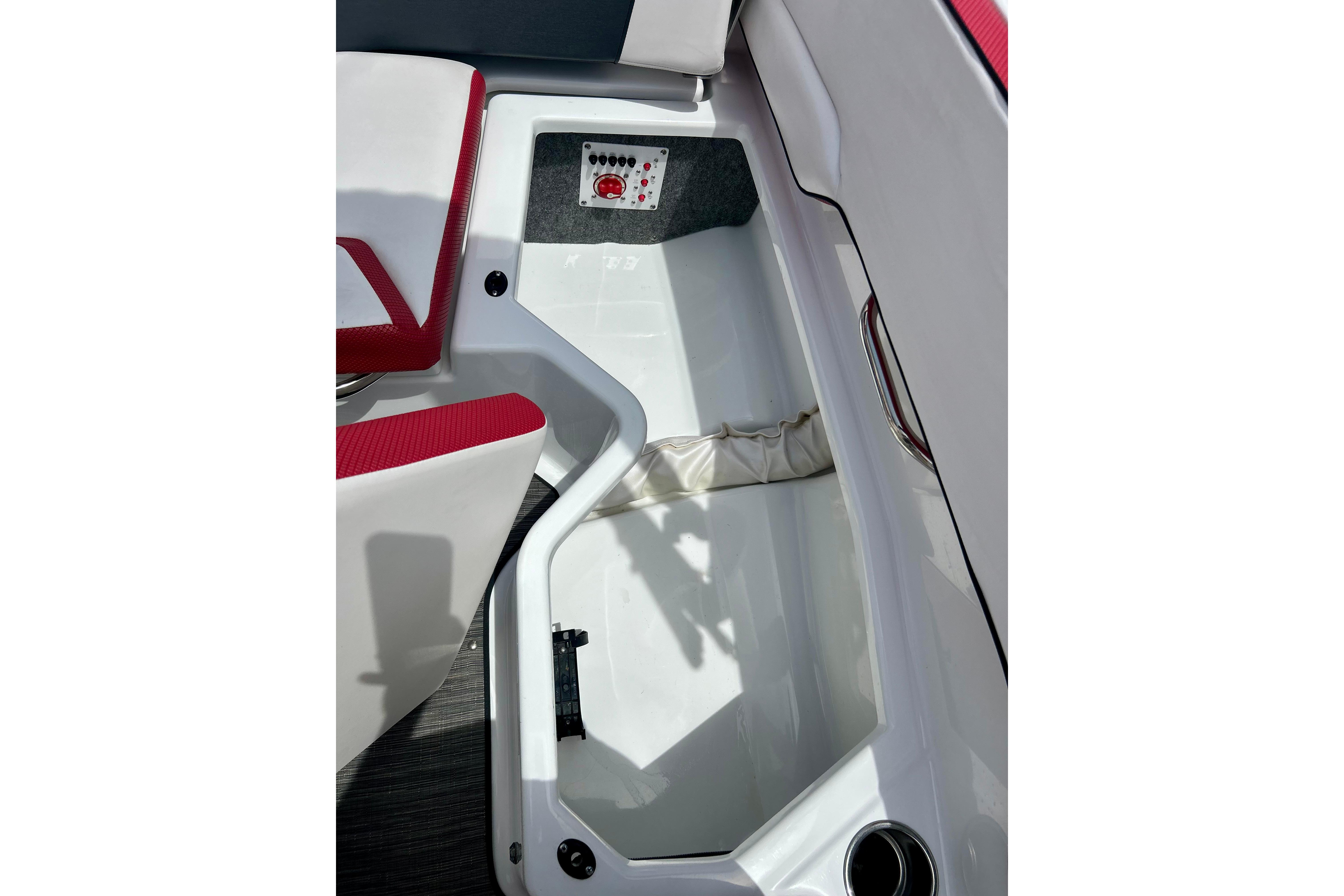 Interior view of 2021 Scarab 195 ID boat, featuring red and white seating.