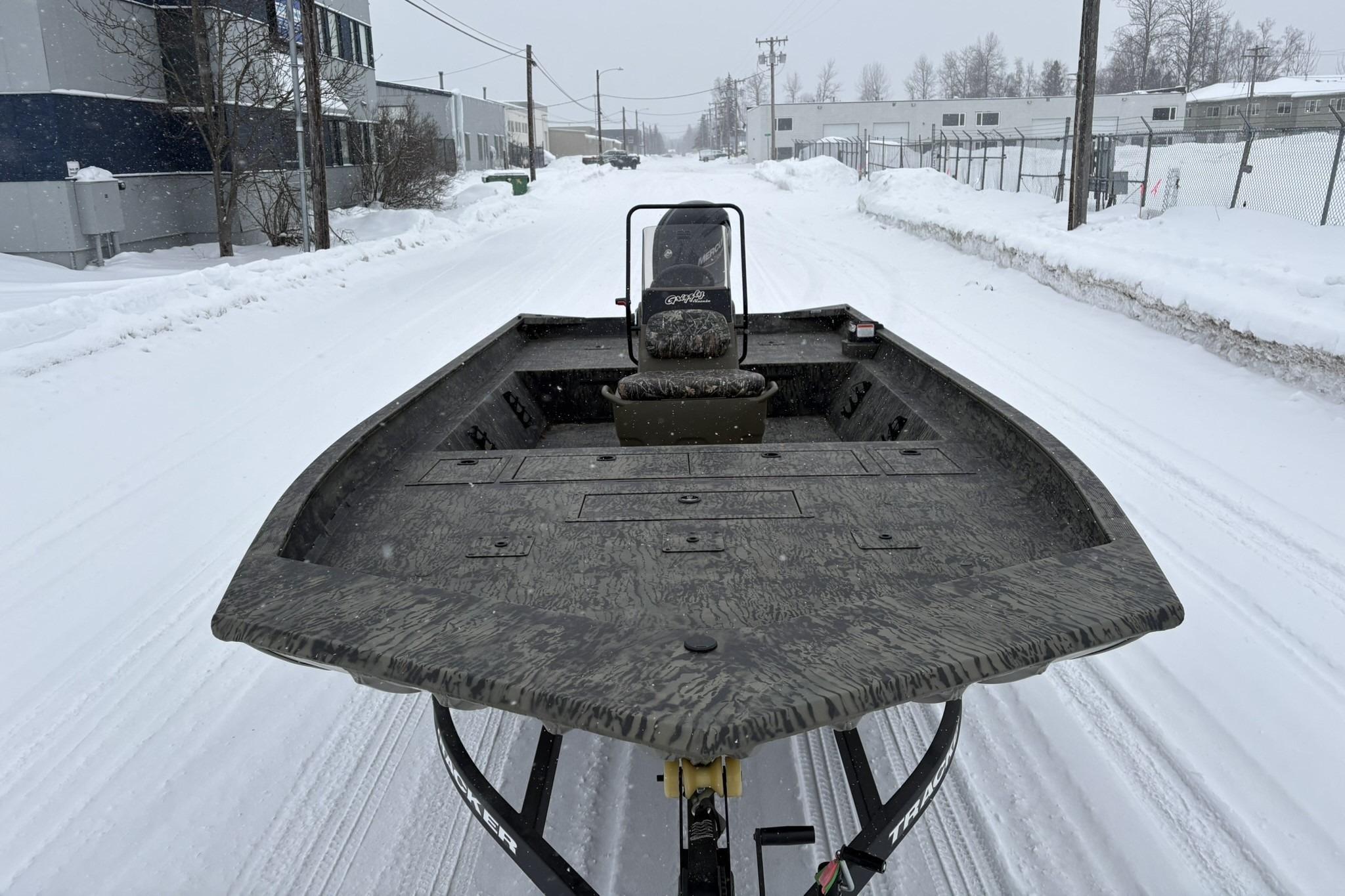 2025 Tracker Grizzly 2072 CC boat on snowy street, showcasing rugged design.
