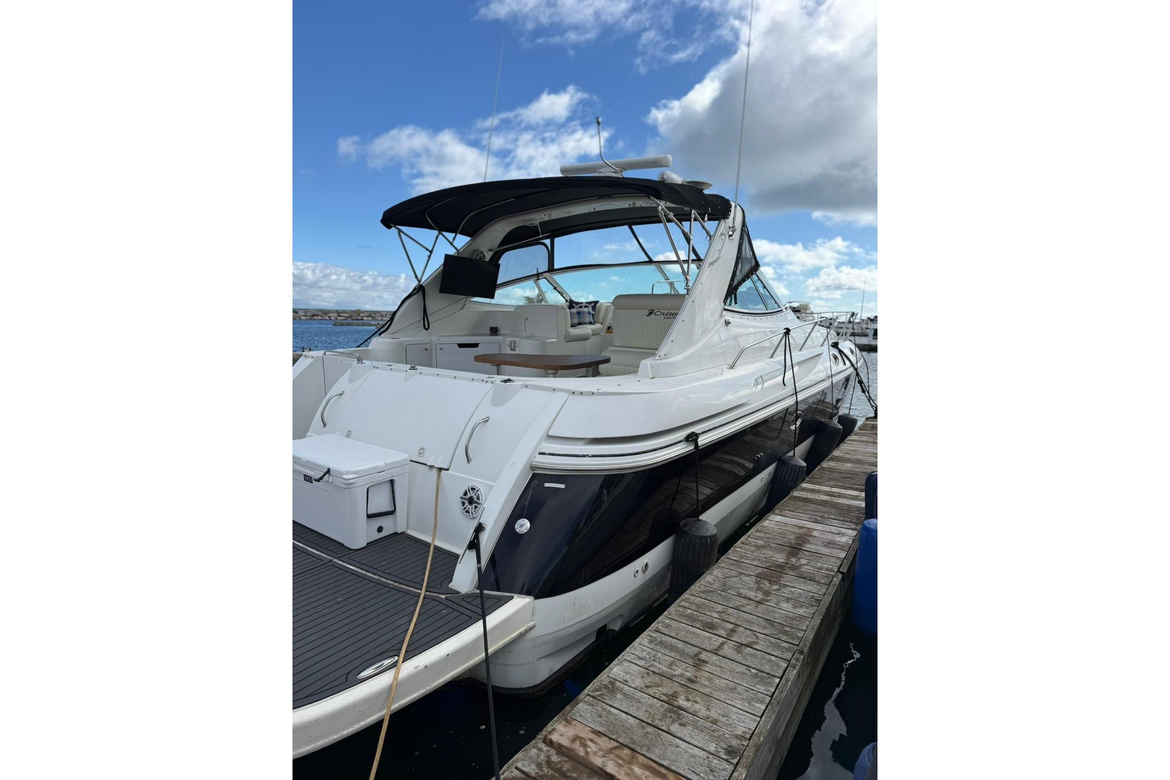 2001 Cruisers Yachts 3870 Express docked, showcasing sleek design and spacious deck.