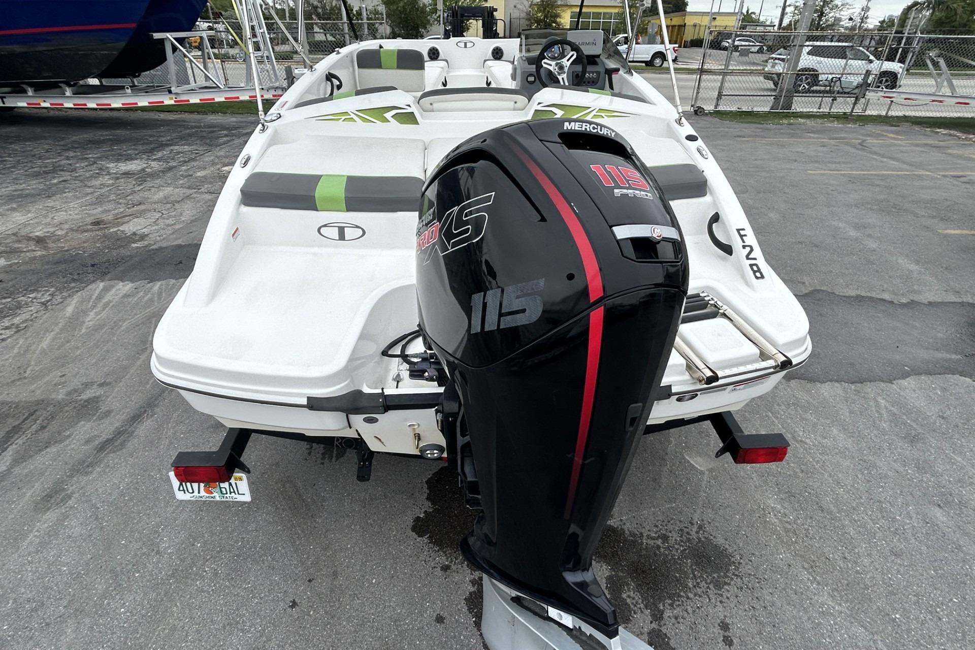 2022 Tahoe T18 boat with Mercury 115 Pro XS outboard motor, parked outdoors.