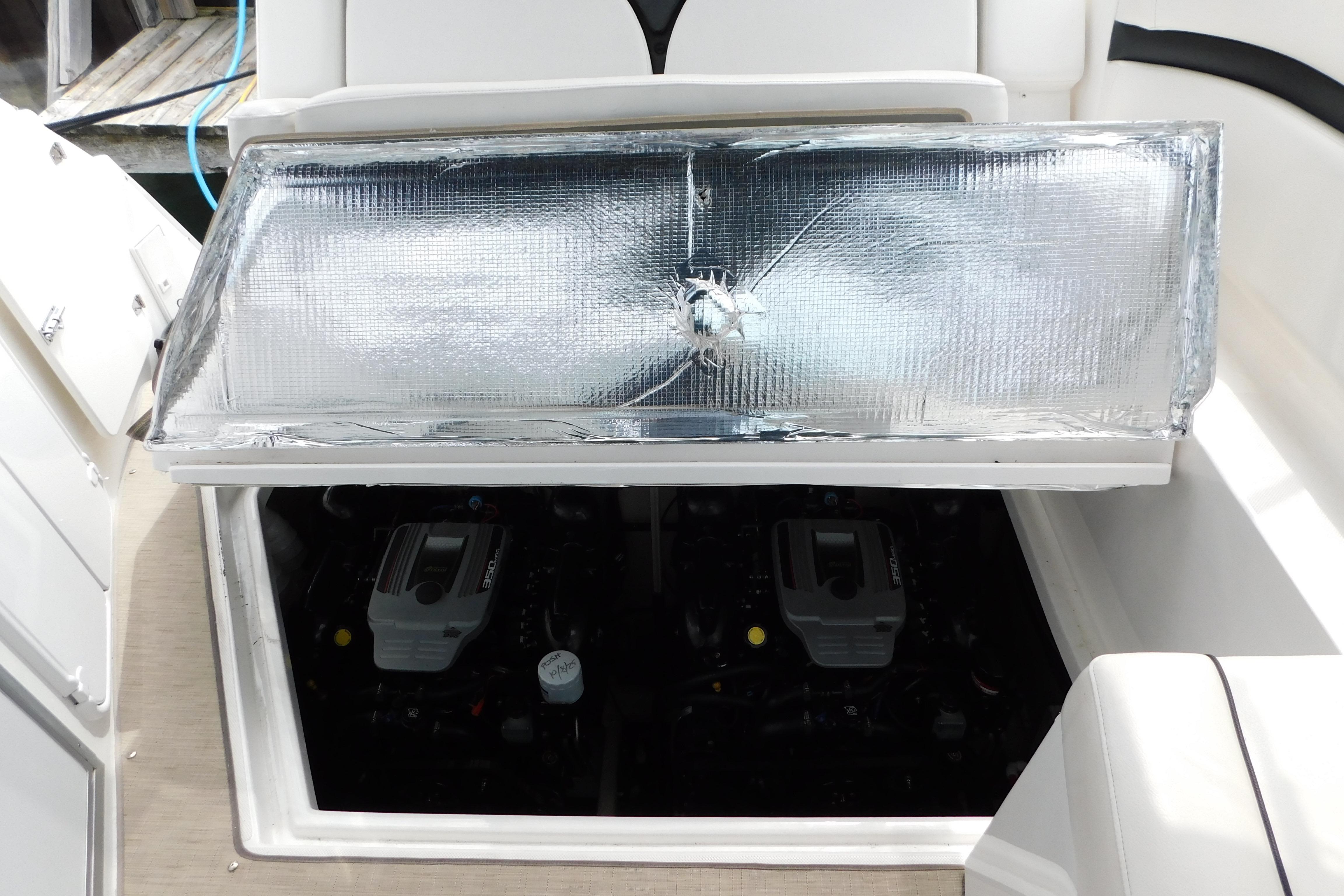 2017 Rinker EX 320 boat engine compartment with reflective insulation cover.
