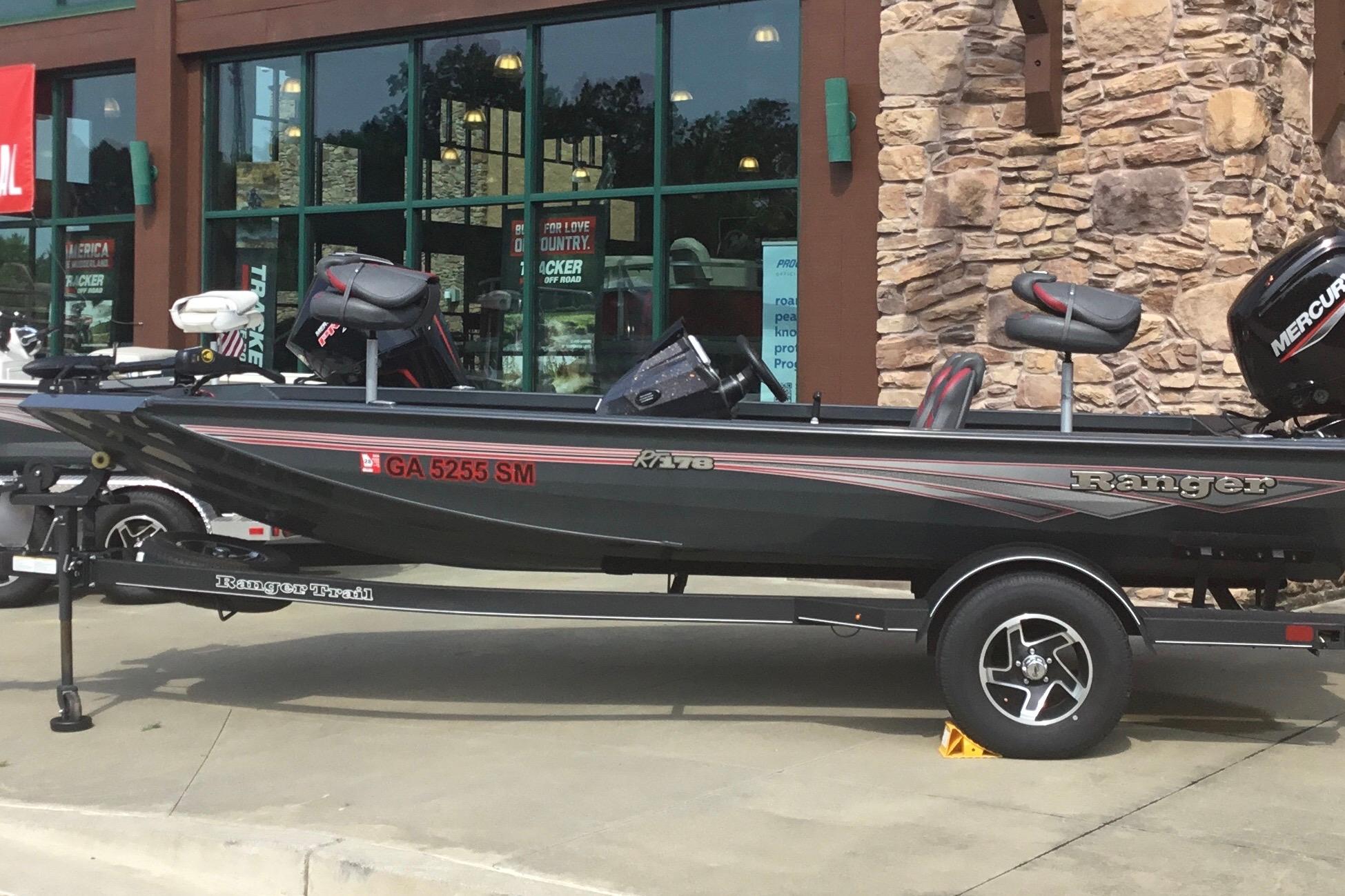 2025 Ranger RT178 boat on trailer outside a store, featuring a Mercury engine.