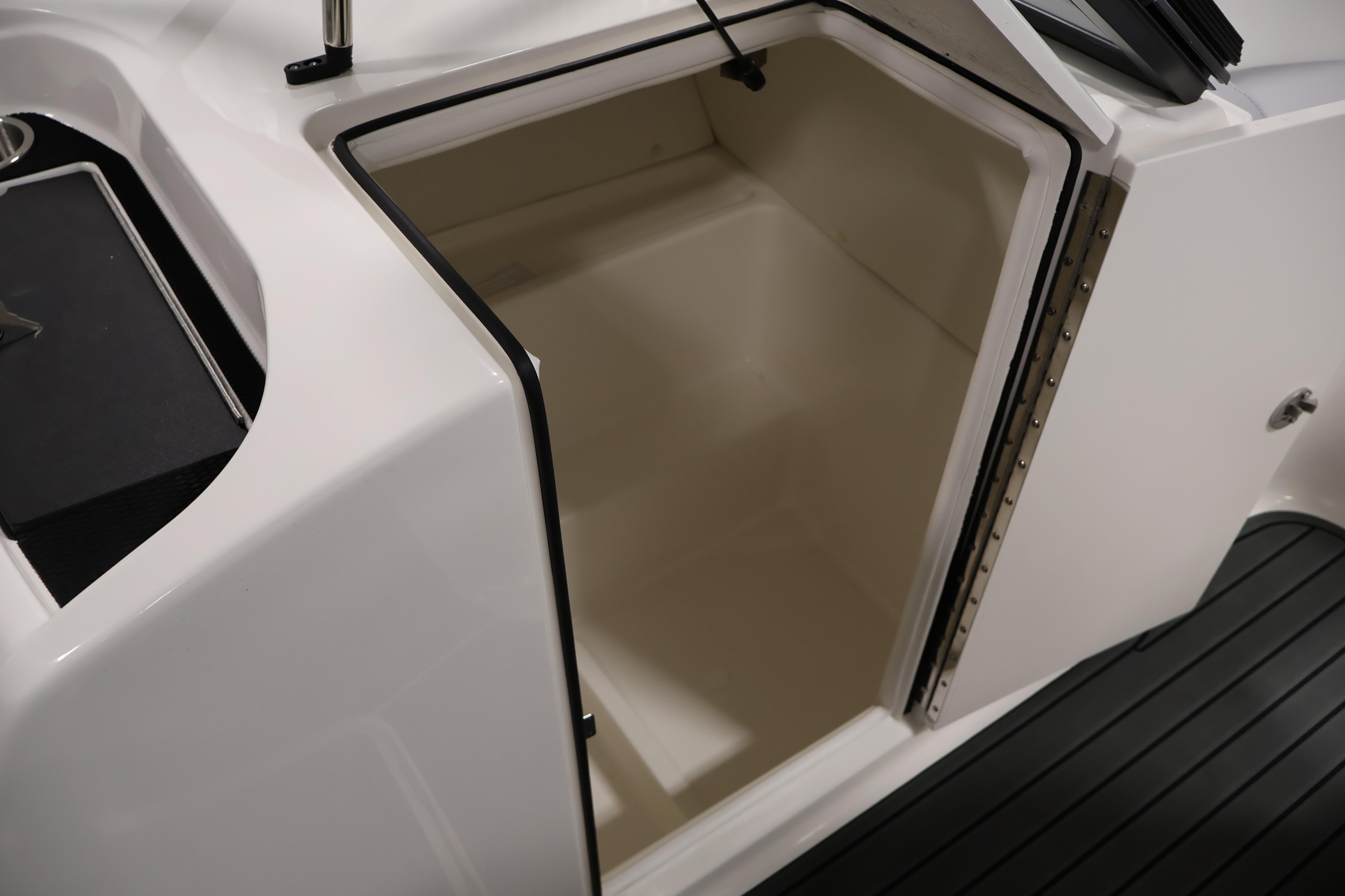 2026 Bayliner VR6 Bowrider I/O storage compartment with open hatch and sleek design.