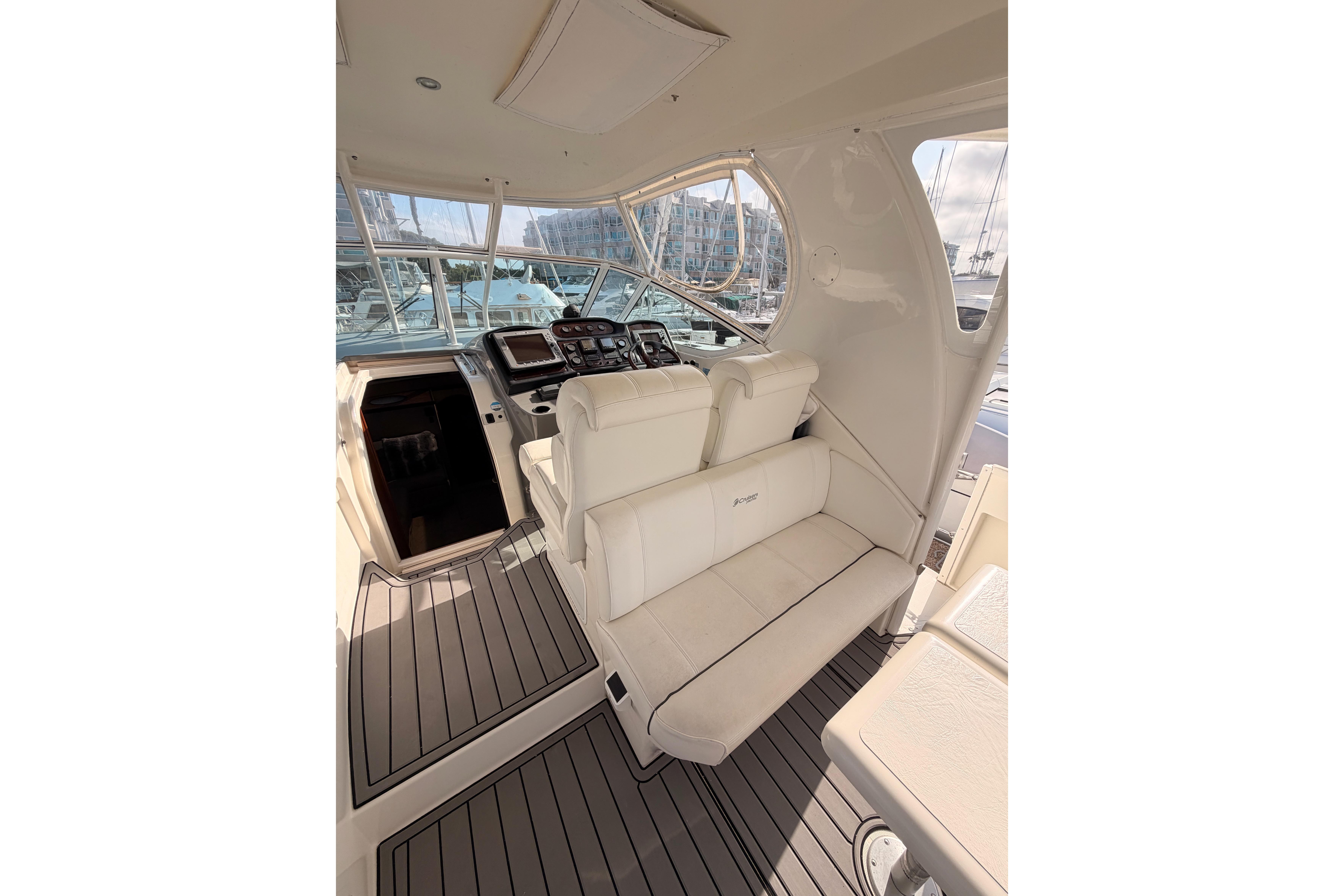 2005 Cruisers Yachts 405 Express Motoryacht cockpit with white seating and navigation controls.