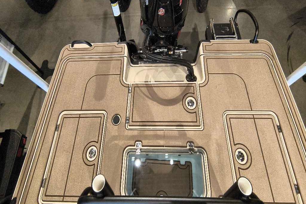 2026 Mako 18 Pro Skiff Backwater Edition boat deck with storage compartments and motor.