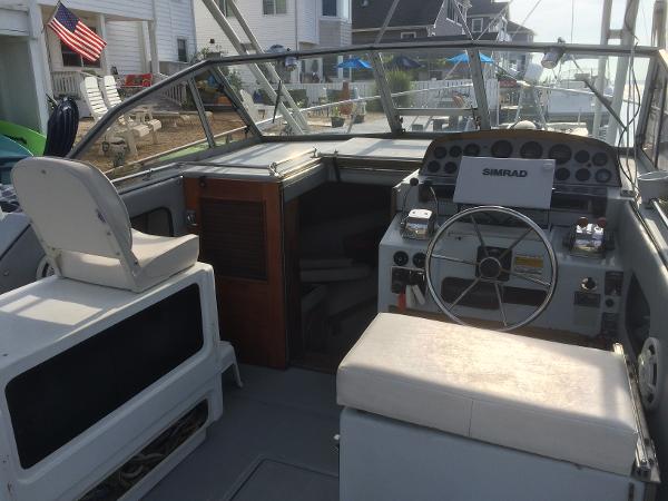 1987 Boston Whaler Cuddy Tower boat interior with steering wheel and seating.