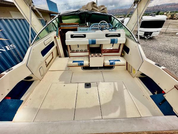 1987 Sea Ray 270 Sundancer boat interior with seating and steering wheel.