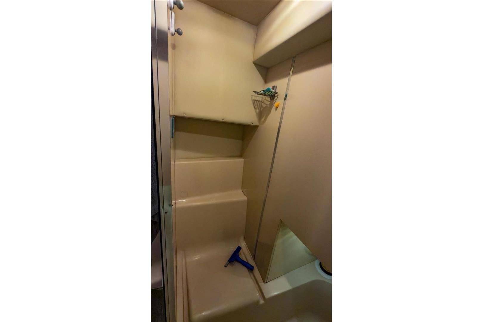 Shower area in 2002 Bayliner 3988 Command Bridge Motoryacht, featuring beige interior.
