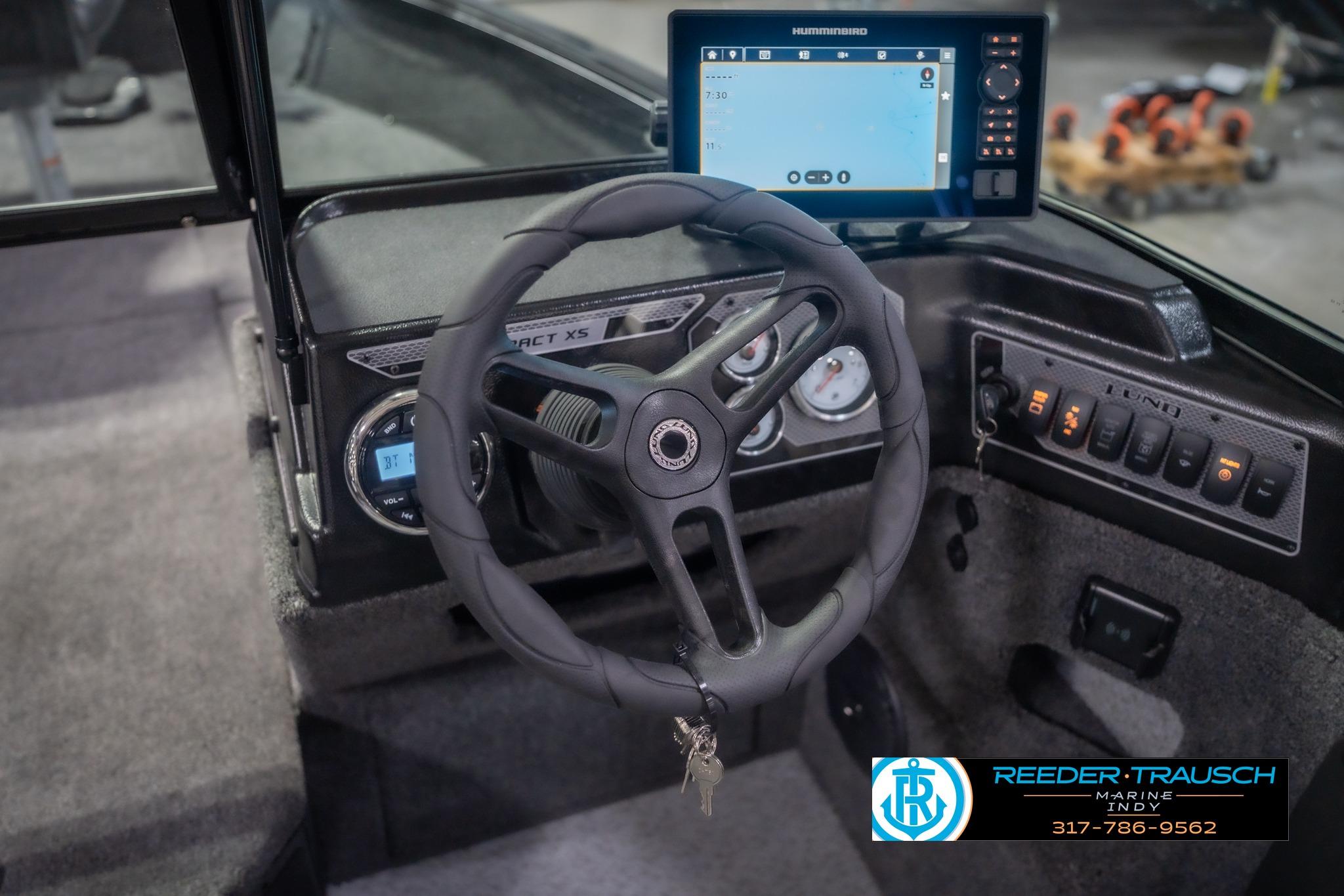 2026 Lund 2075 Impact XS boat dashboard with steering wheel and navigation display.