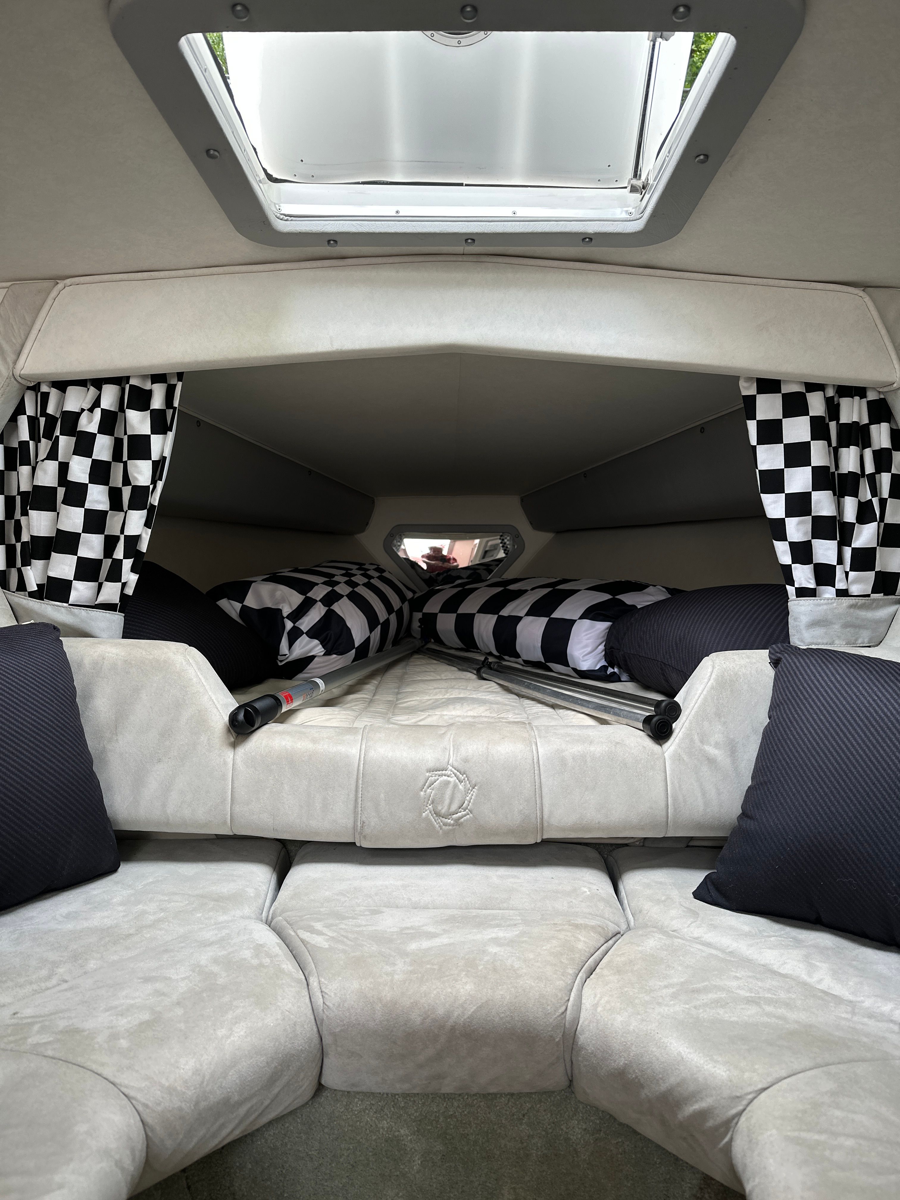 Interior of a 1994 Fountain EXECUTIONER with checkered curtains and cushions.