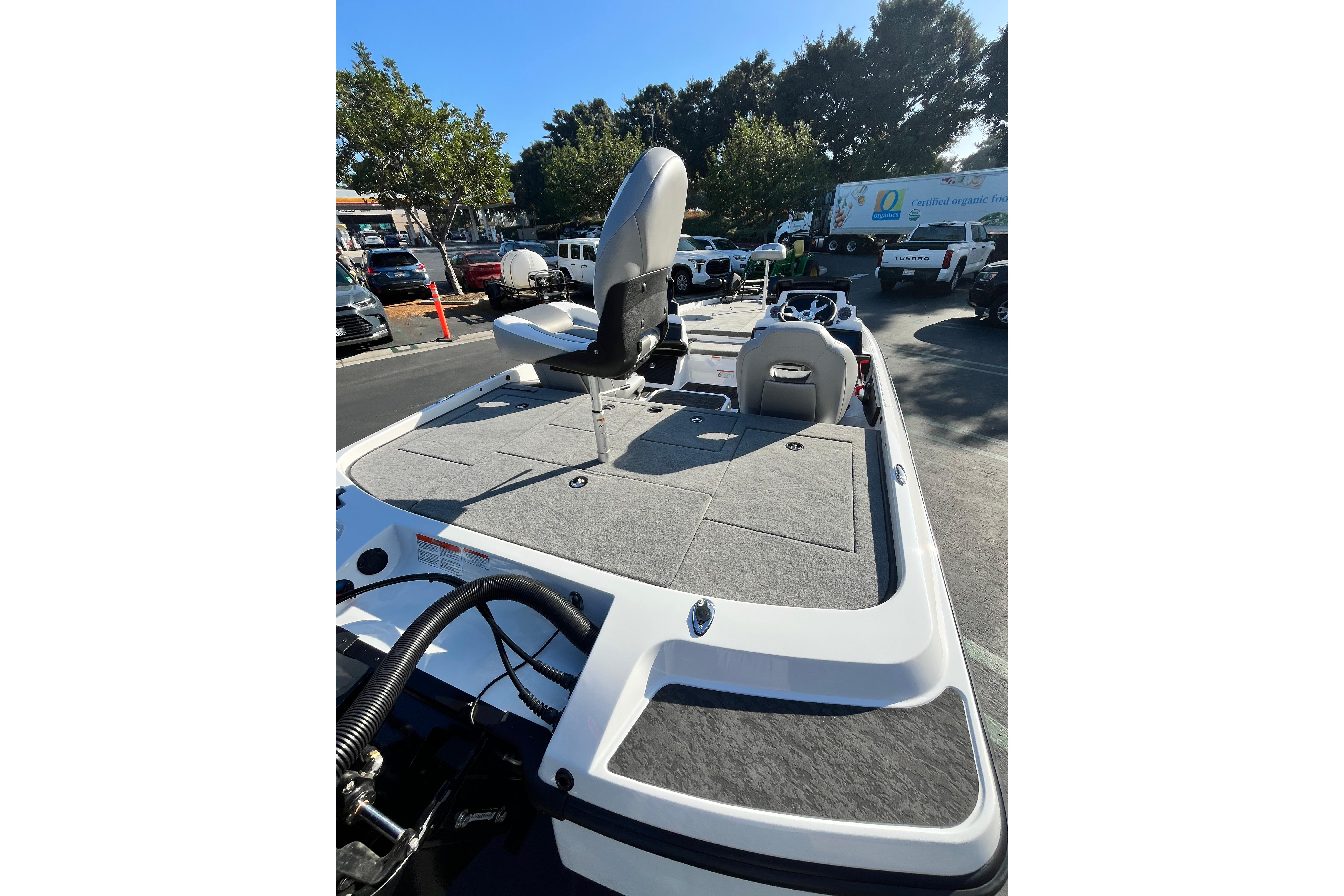 2026 Nitro Z21 XL Pro boat with spacious deck and seating in a parking lot.