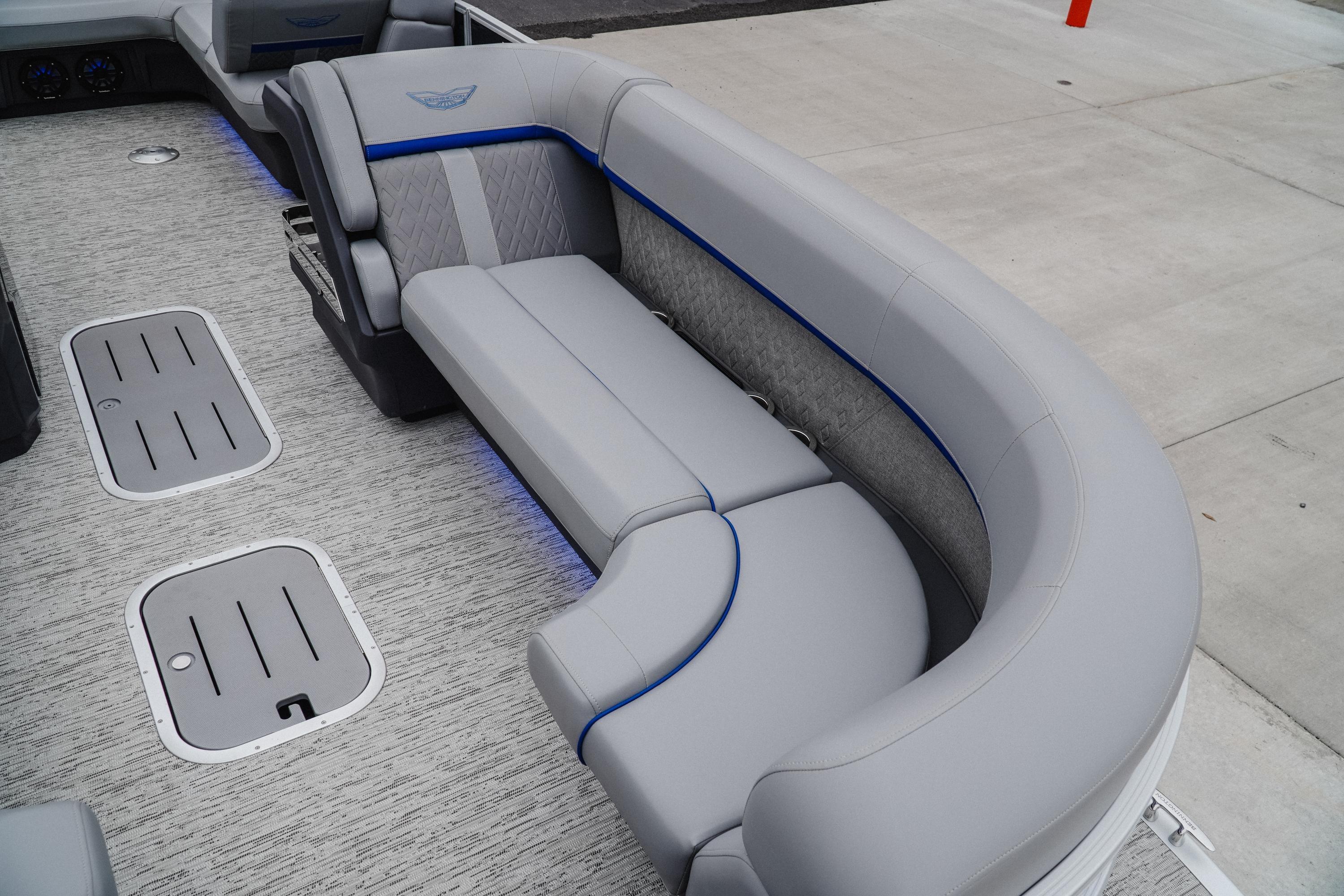 2025 Bennington 24MSB boat interior with gray seating and blue accents.