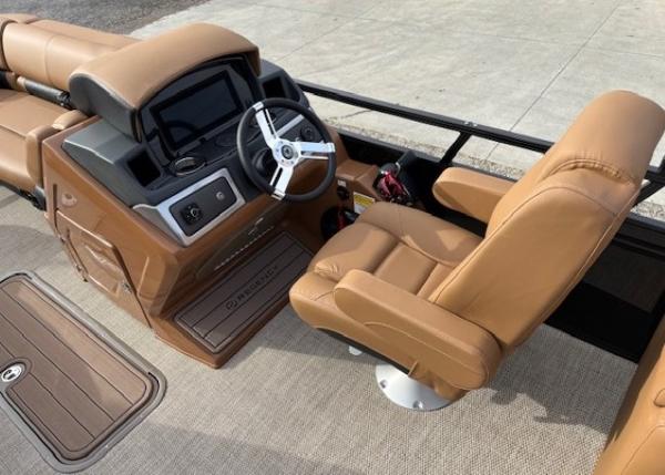 2025 Regency 230 LE3 boat interior with tan leather seats and modern dashboard.
