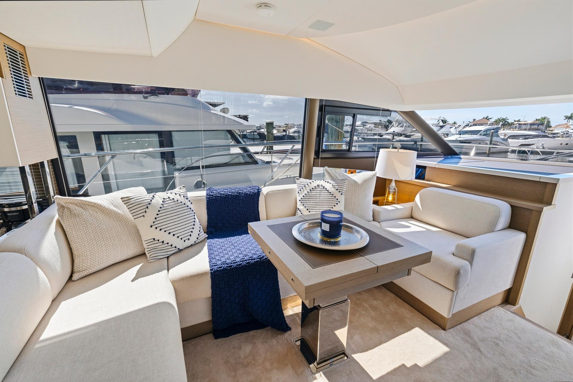 Luxurious interior of 2022 Prestige 520 yacht with elegant seating and modern decor.