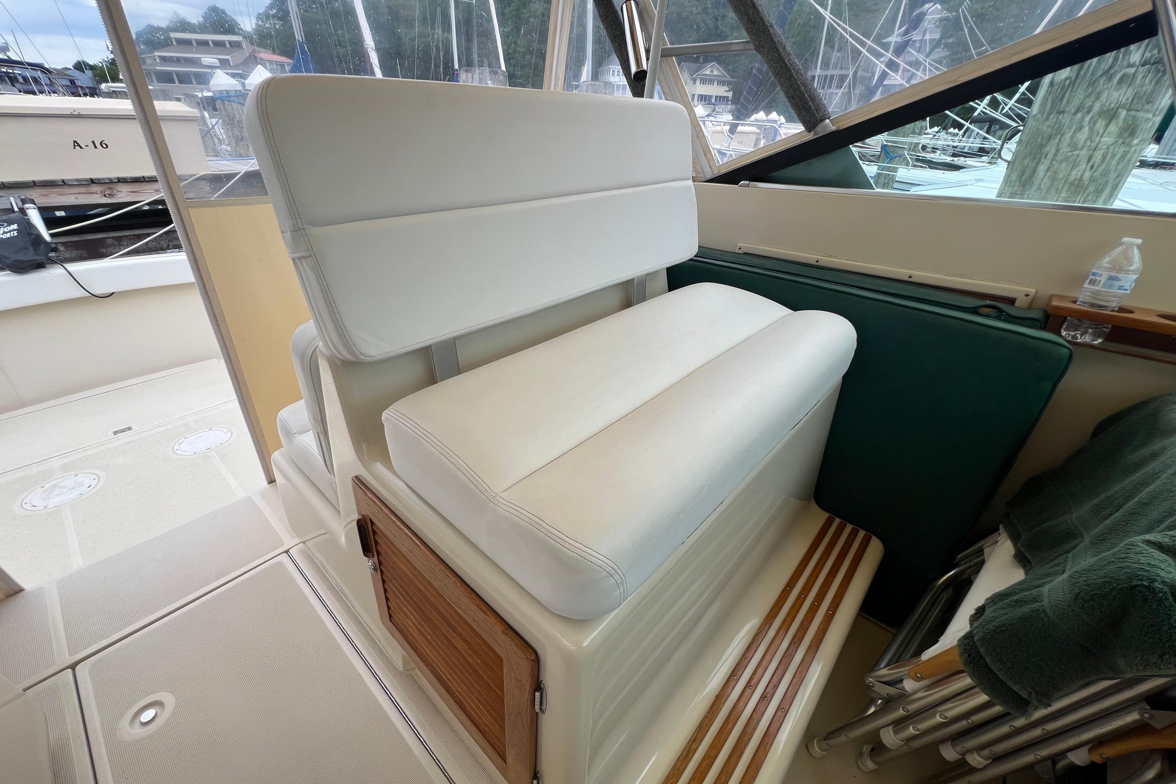 White cushioned seating on 1985 Tiara 36 OPEN boat, docked at marina.