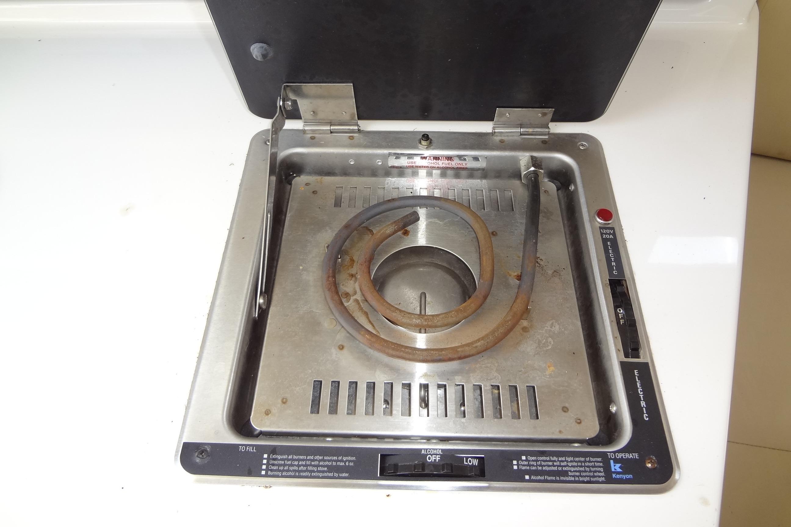 Electric stove in 2000 Chaparral Signature 260 boat galley, featuring a single coil burner.