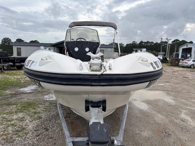 2023 Zodiac NZO-680 boat on trailer, parked outdoors on a cloudy day.