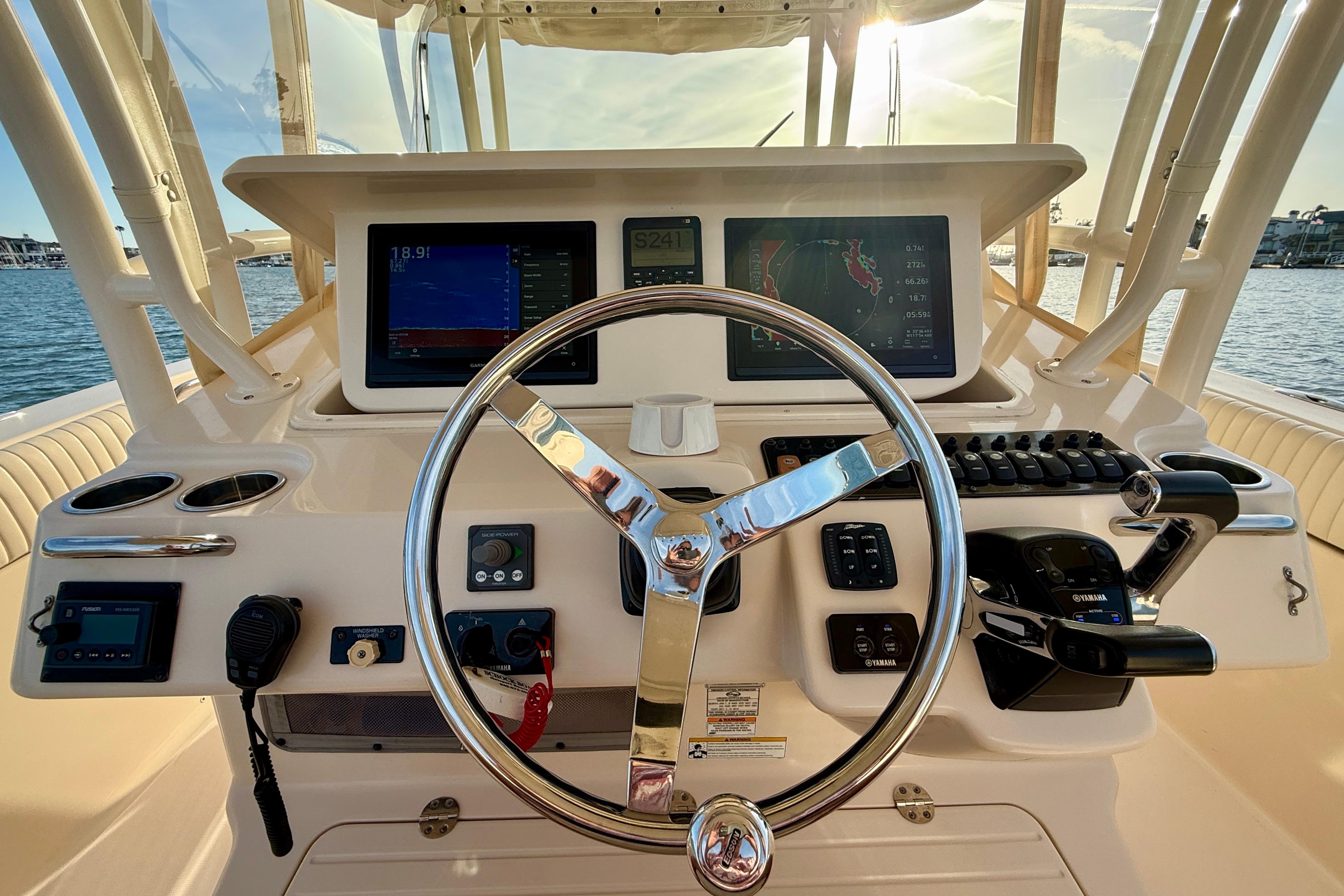 Helm of 2012 Grady-White Canyon 336 boat with modern navigation equipment.