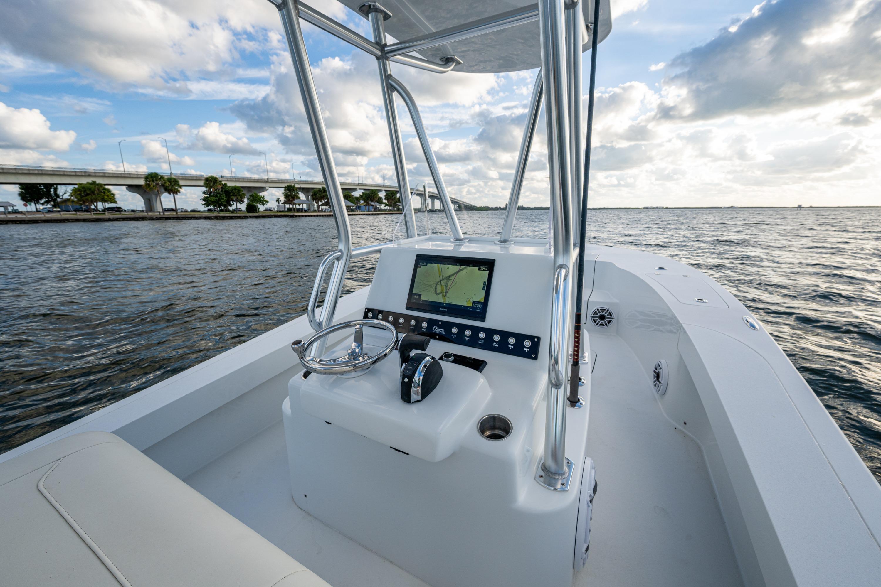 2022 Conch 25 boat with modern console on open water, bridge in background.