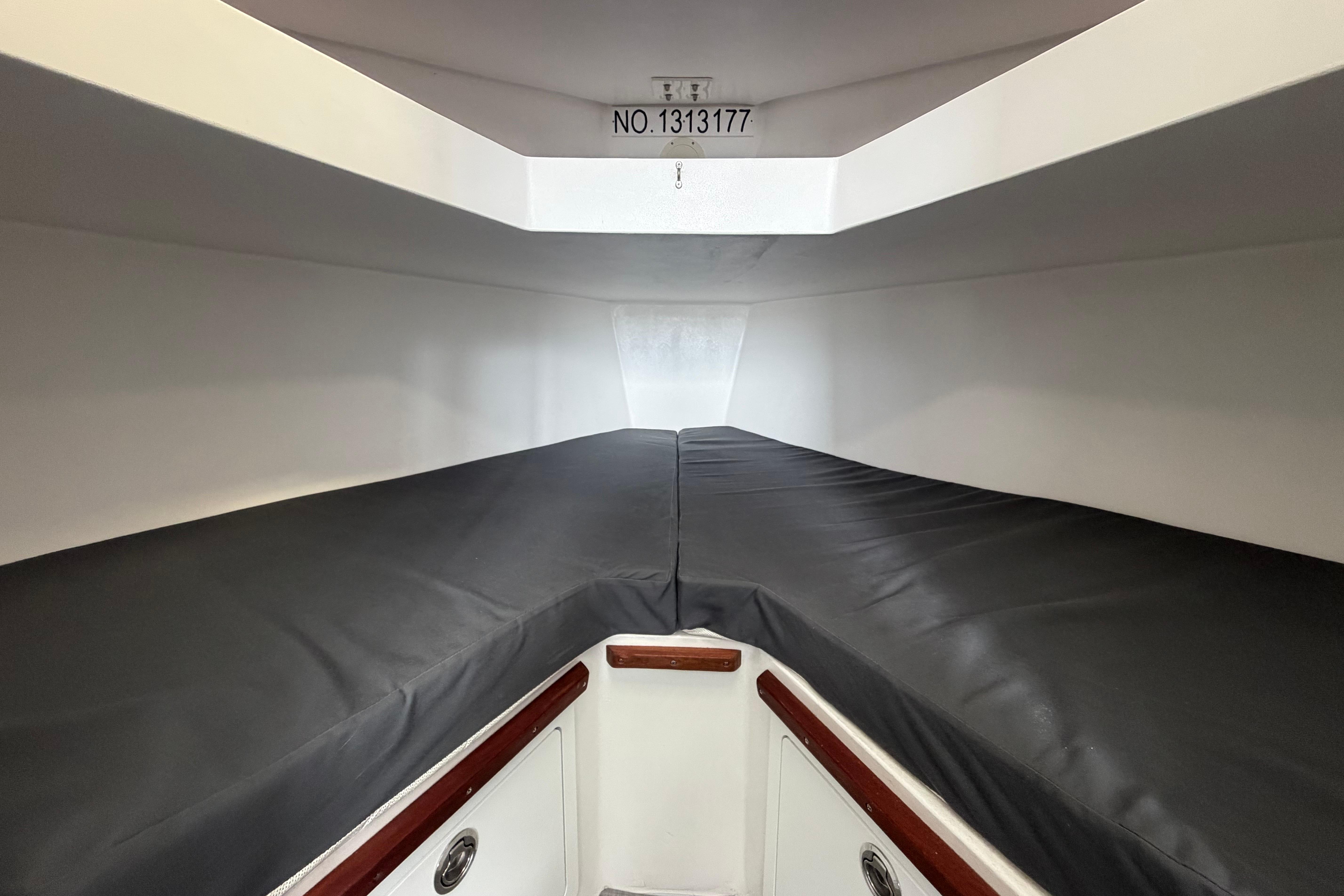 Interior cabin of 2018 H&H Marine Osmond Beal boat, featuring sleek design and storage.