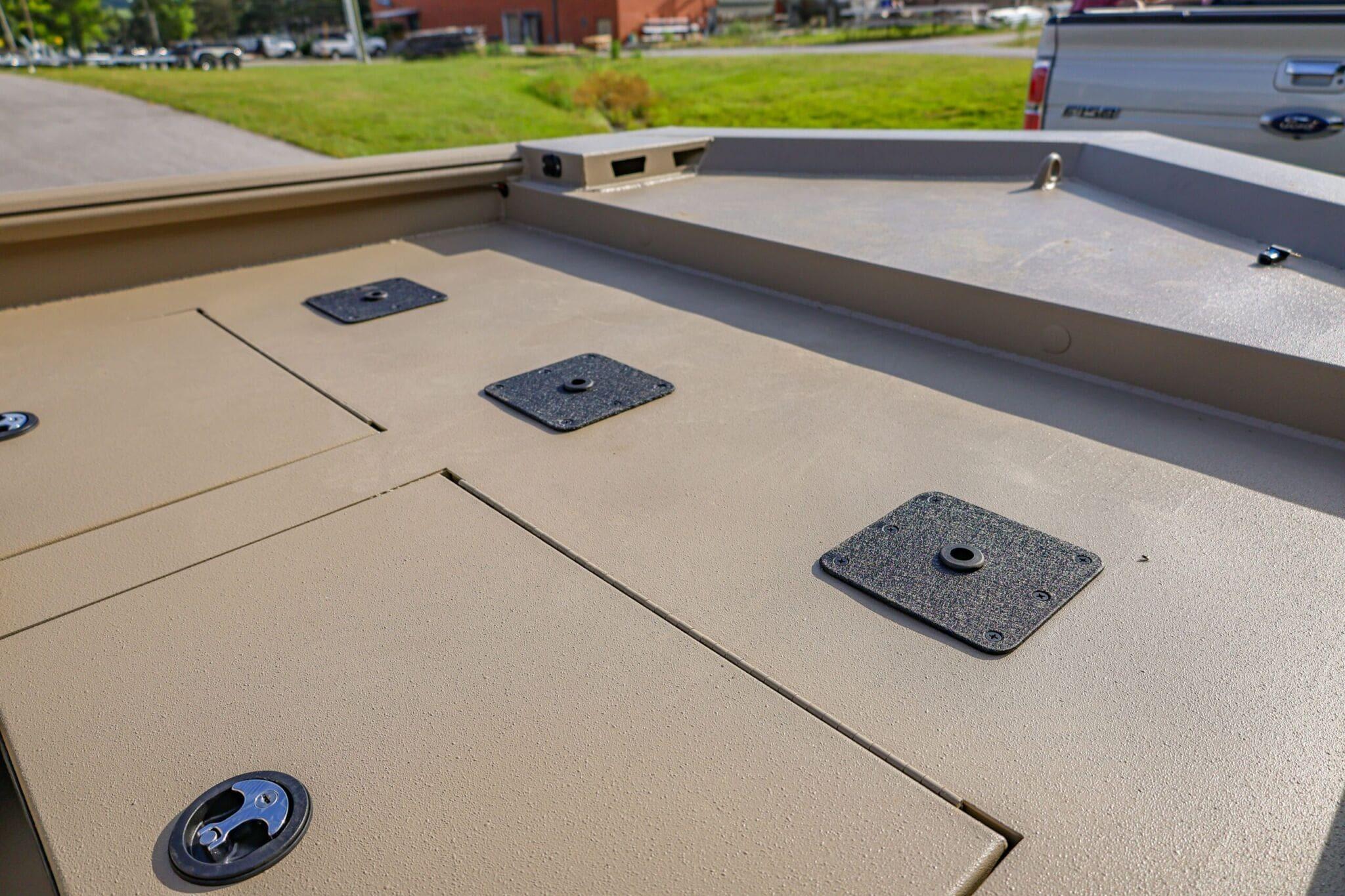 2026 Excel Switchblade boat deck with storage compartments and mounting plates.
